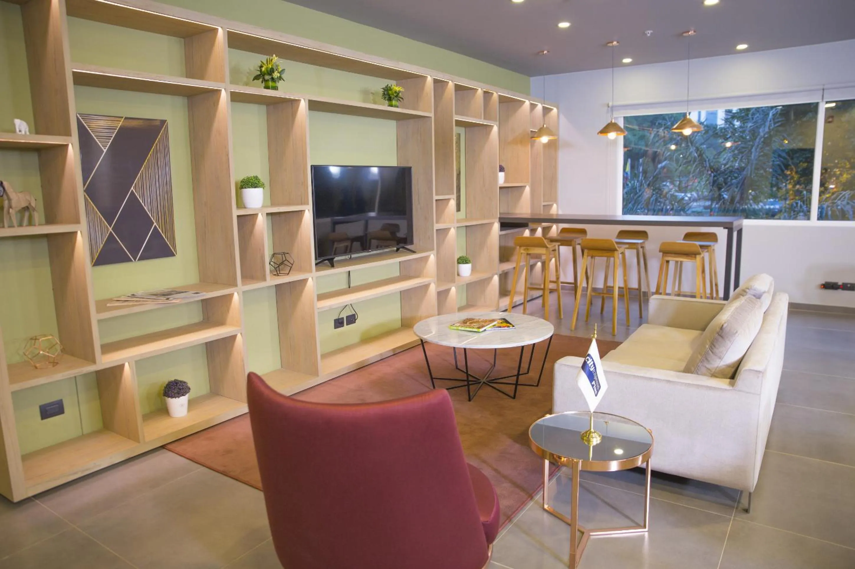 Communal lounge/ TV room in City Express Plus by Marriott Medellín Colombia