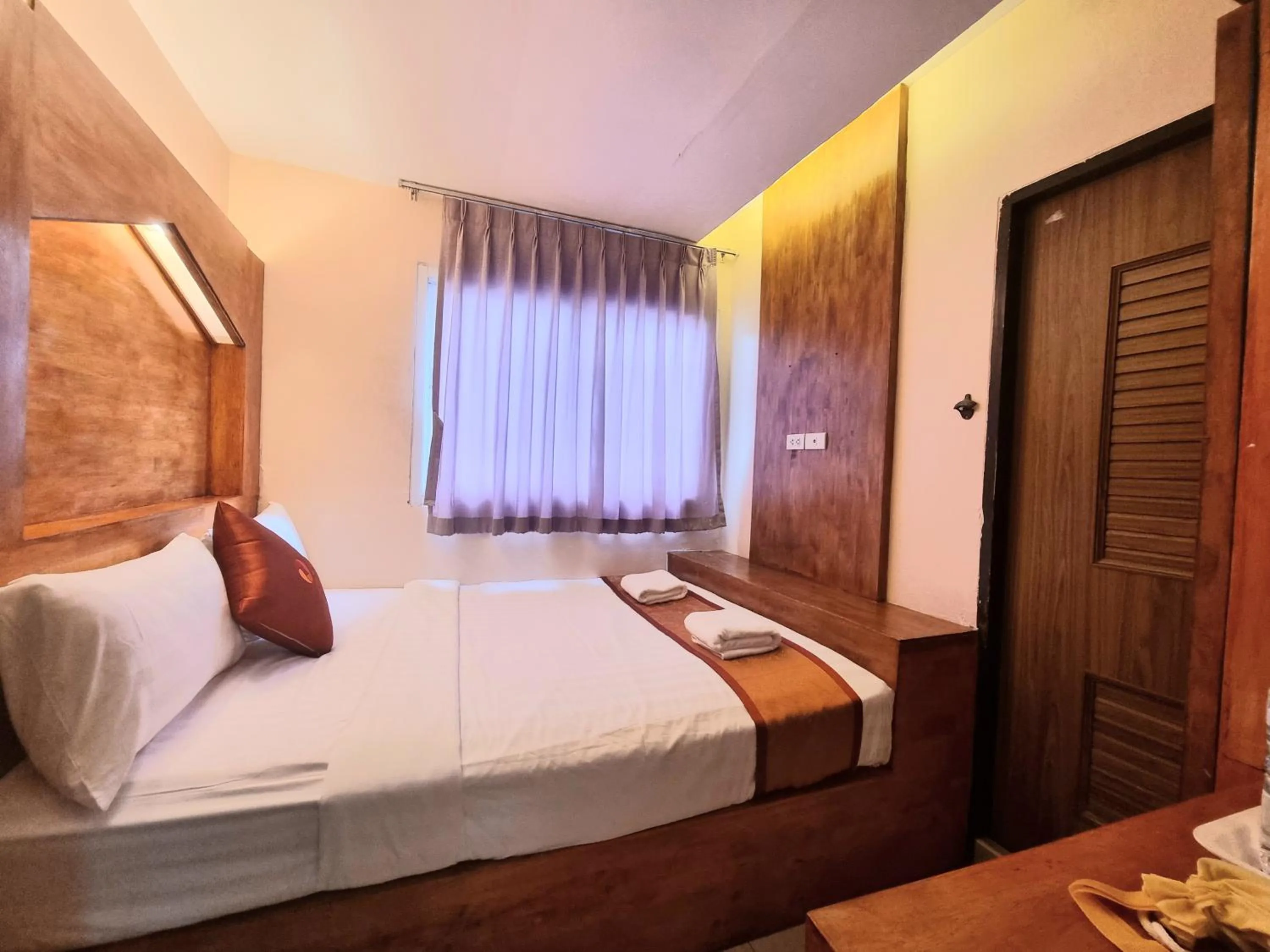 Bed in Cozi Inn Hotel, Bangkok