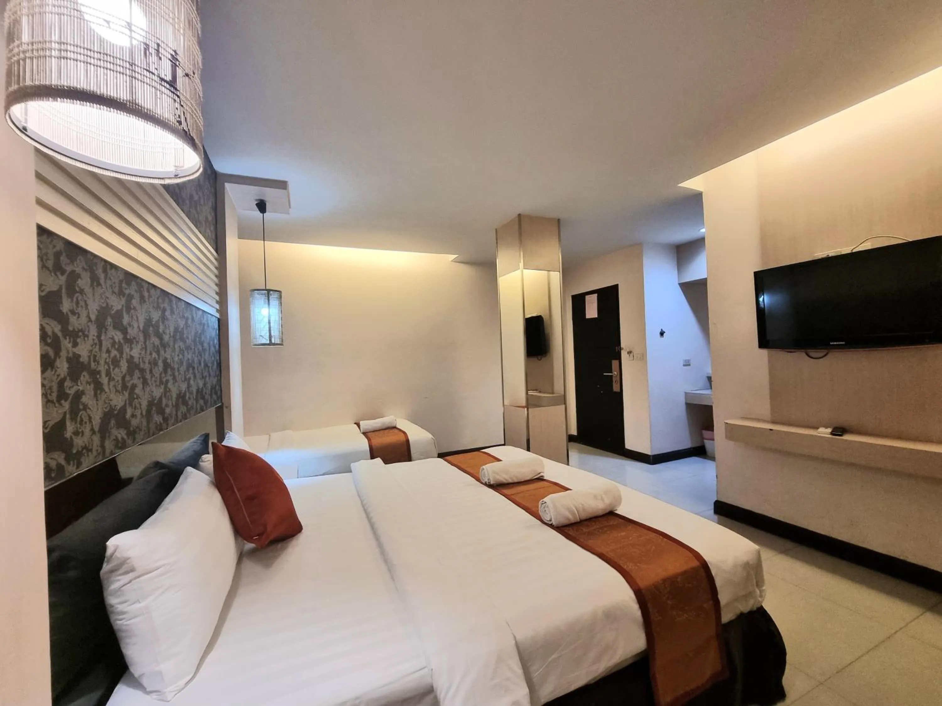 Bed in Cozi Inn Hotel, Bangkok