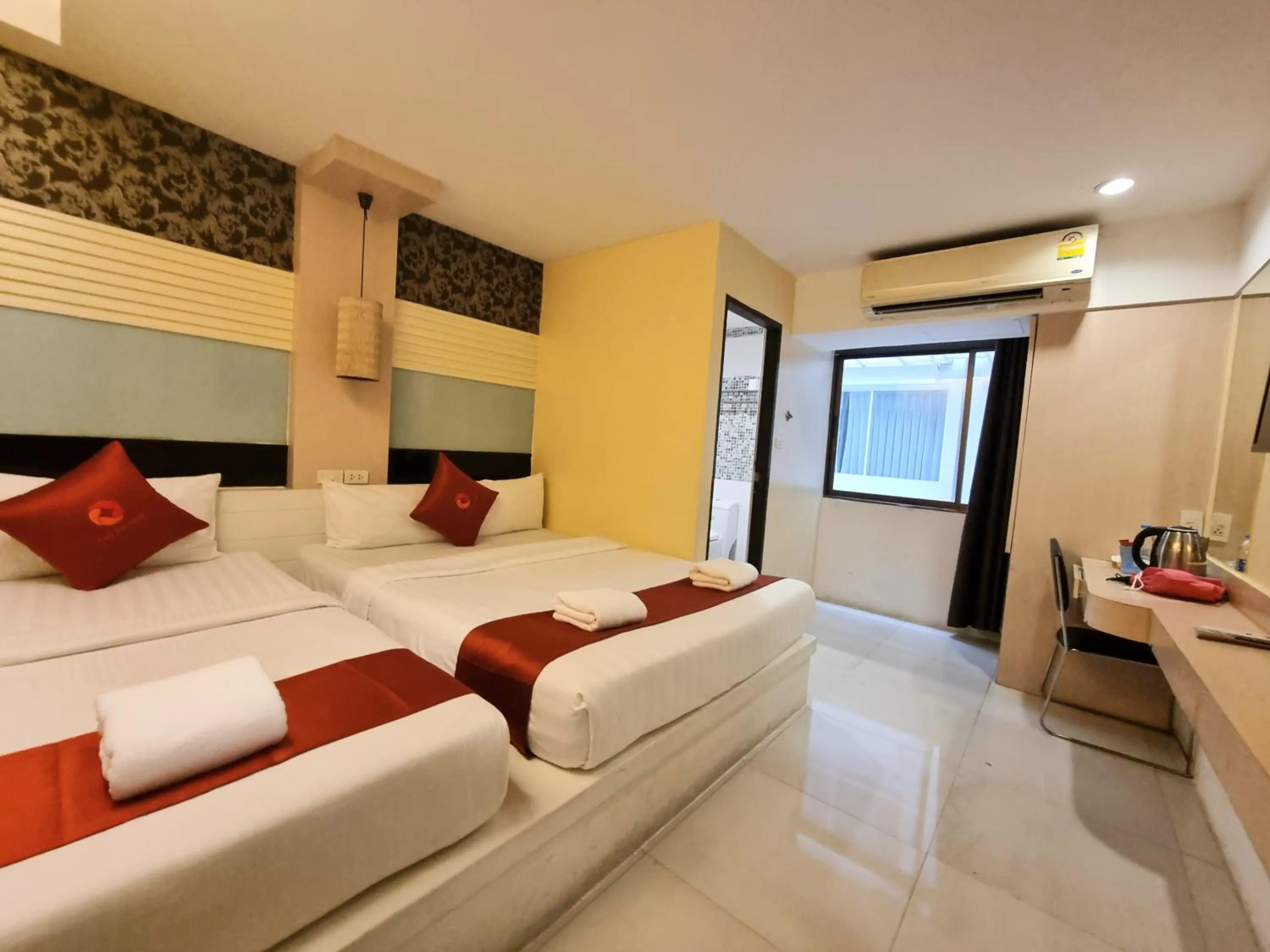 Bed in Cozi Inn Hotel, Bangkok