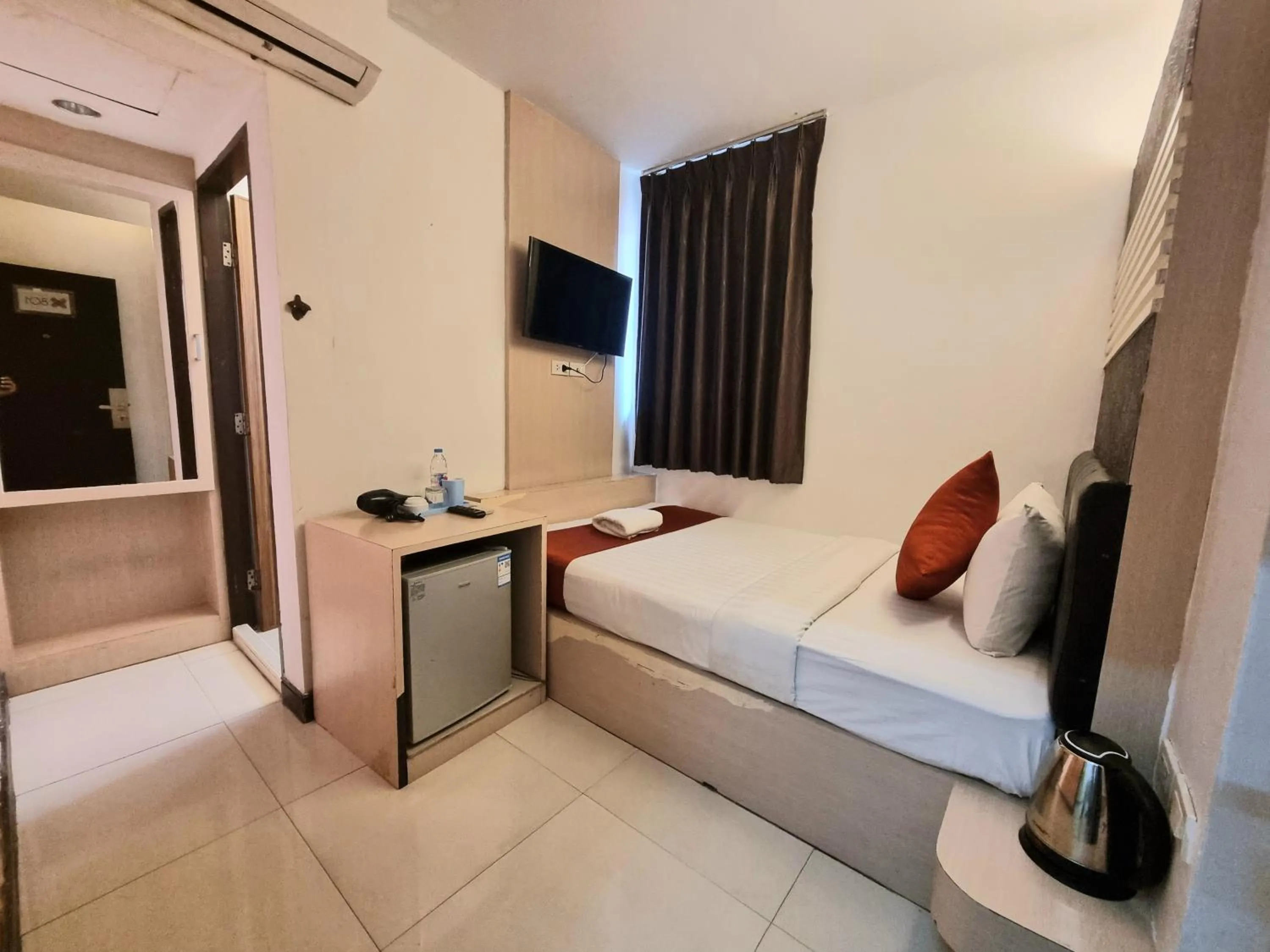 Bed in Cozi Inn Hotel, Bangkok