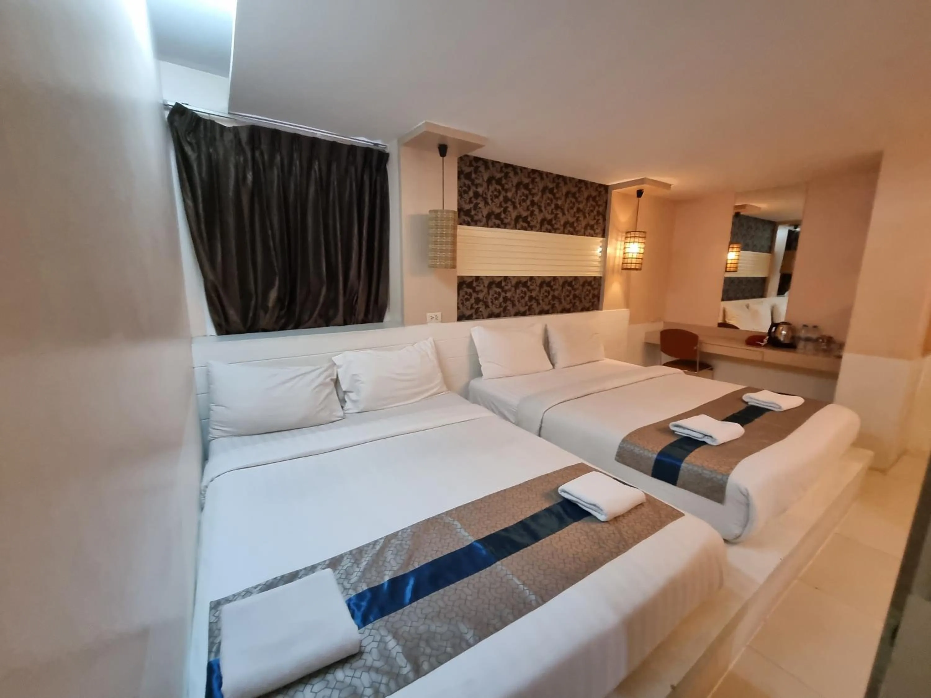 Bed in Cozi Inn Hotel, Bangkok