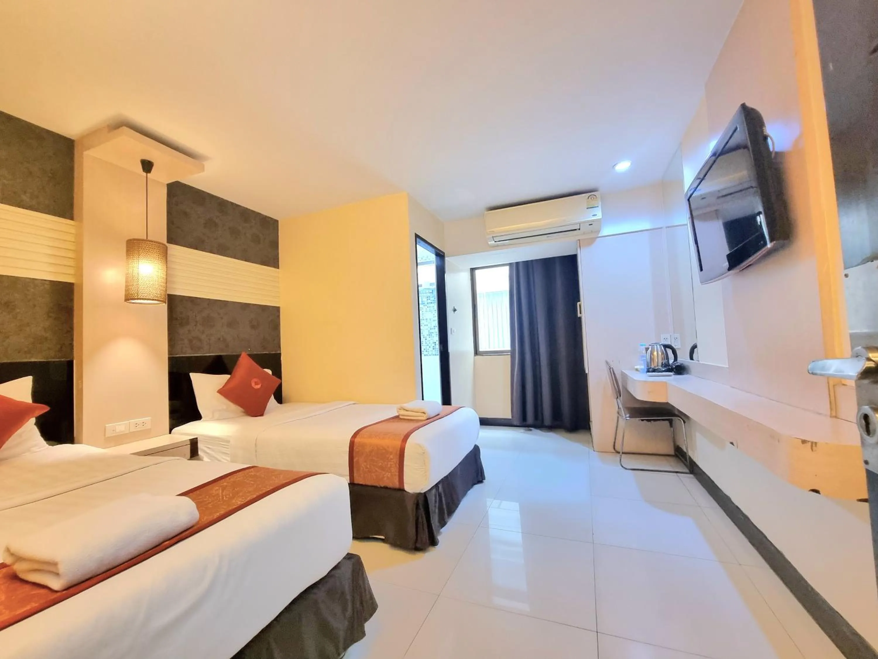 Bed in Cozi Inn Hotel, Bangkok