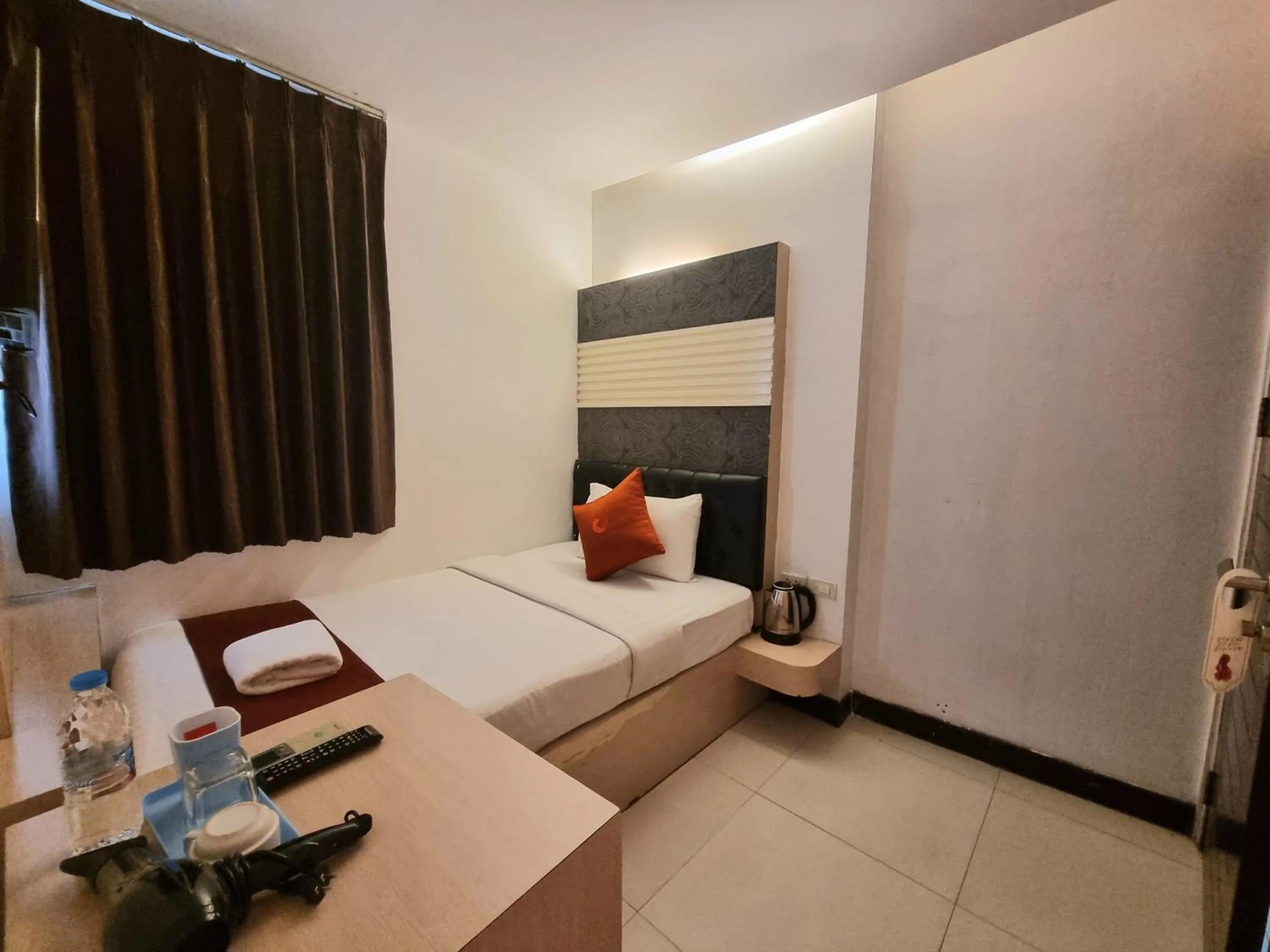 Bed in Cozi Inn Hotel, Bangkok