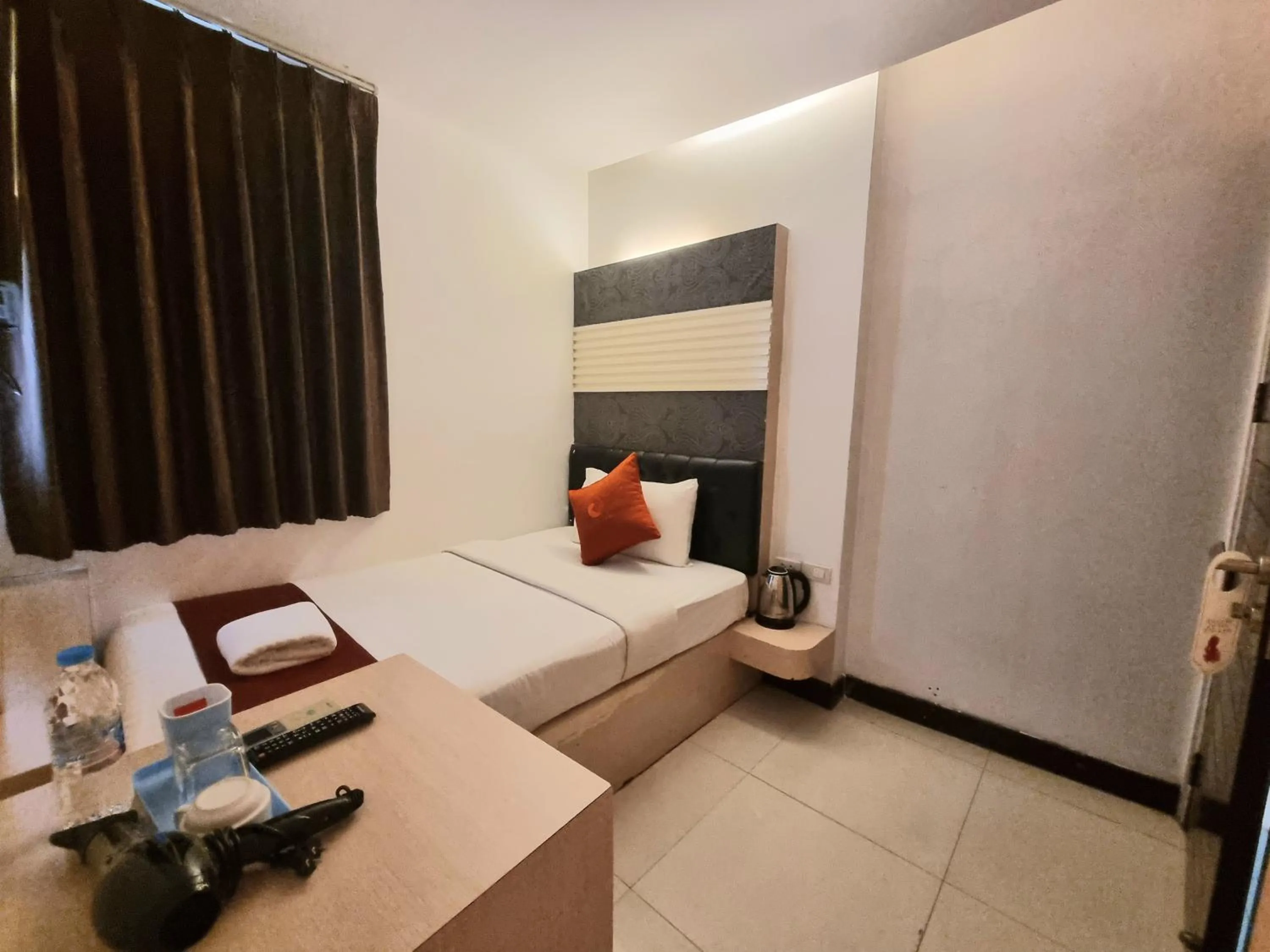 Bed in Cozi Inn Hotel, Bangkok