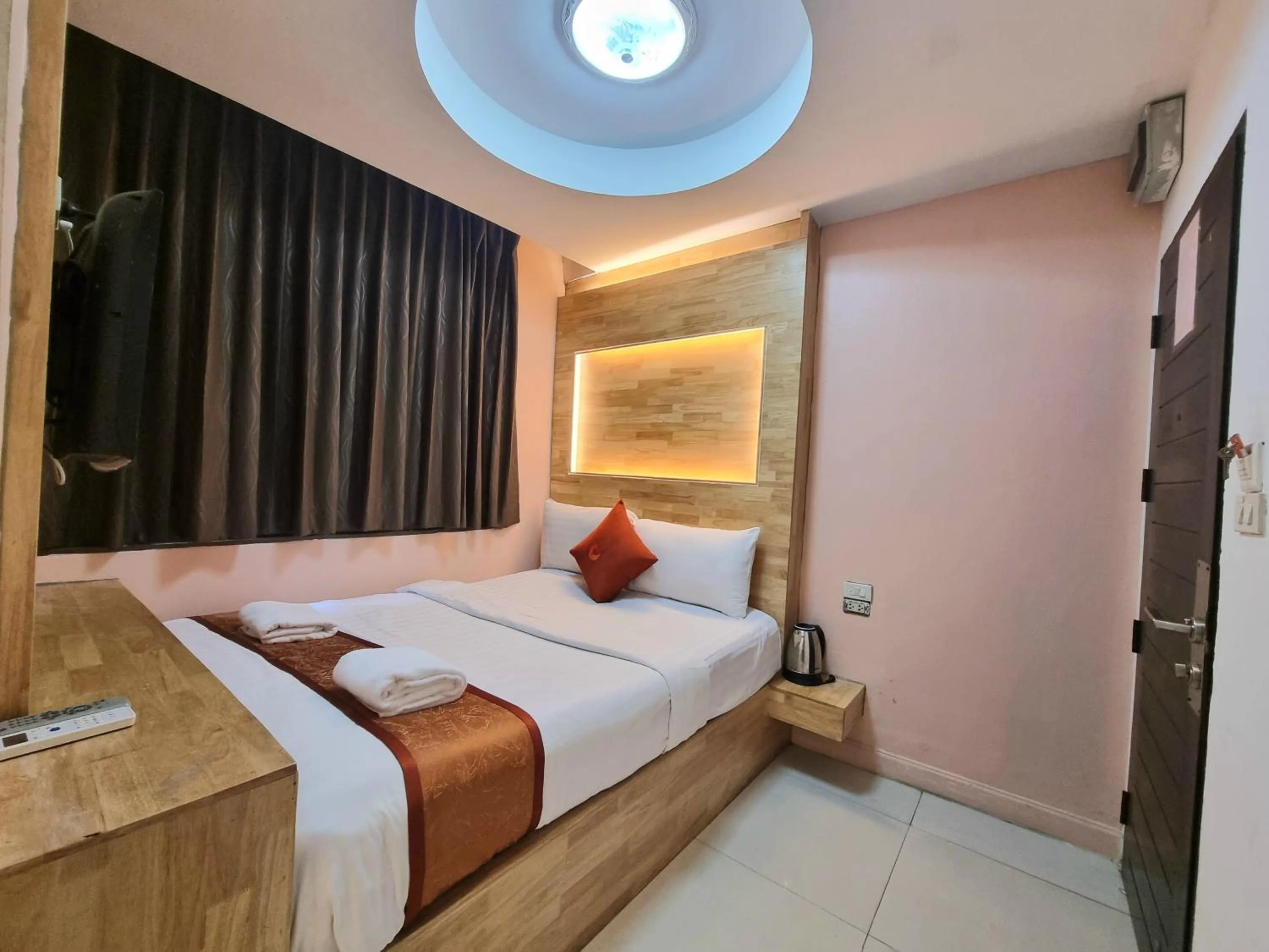 Bed in Cozi Inn Hotel, Bangkok