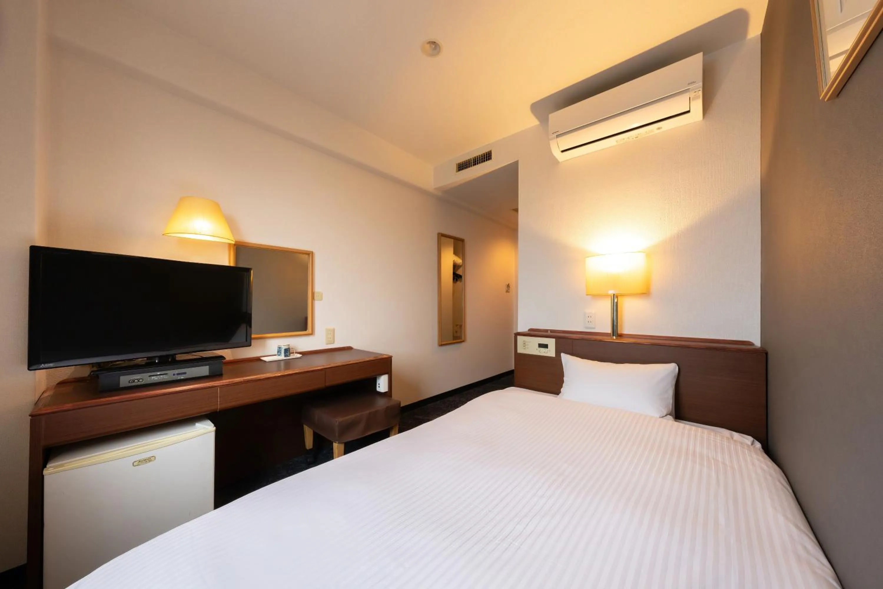 Photo of the whole room, Bed in Omura Central Hotel