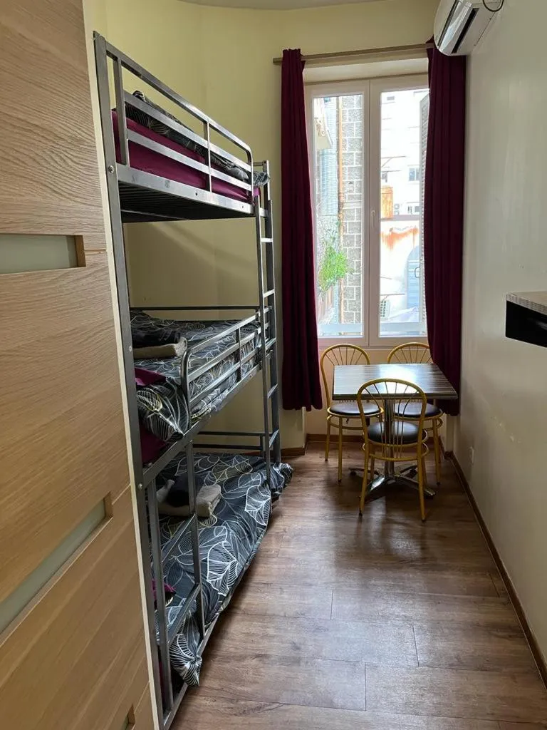 Photo of the whole room, Bed in Hôtel Lyonnais