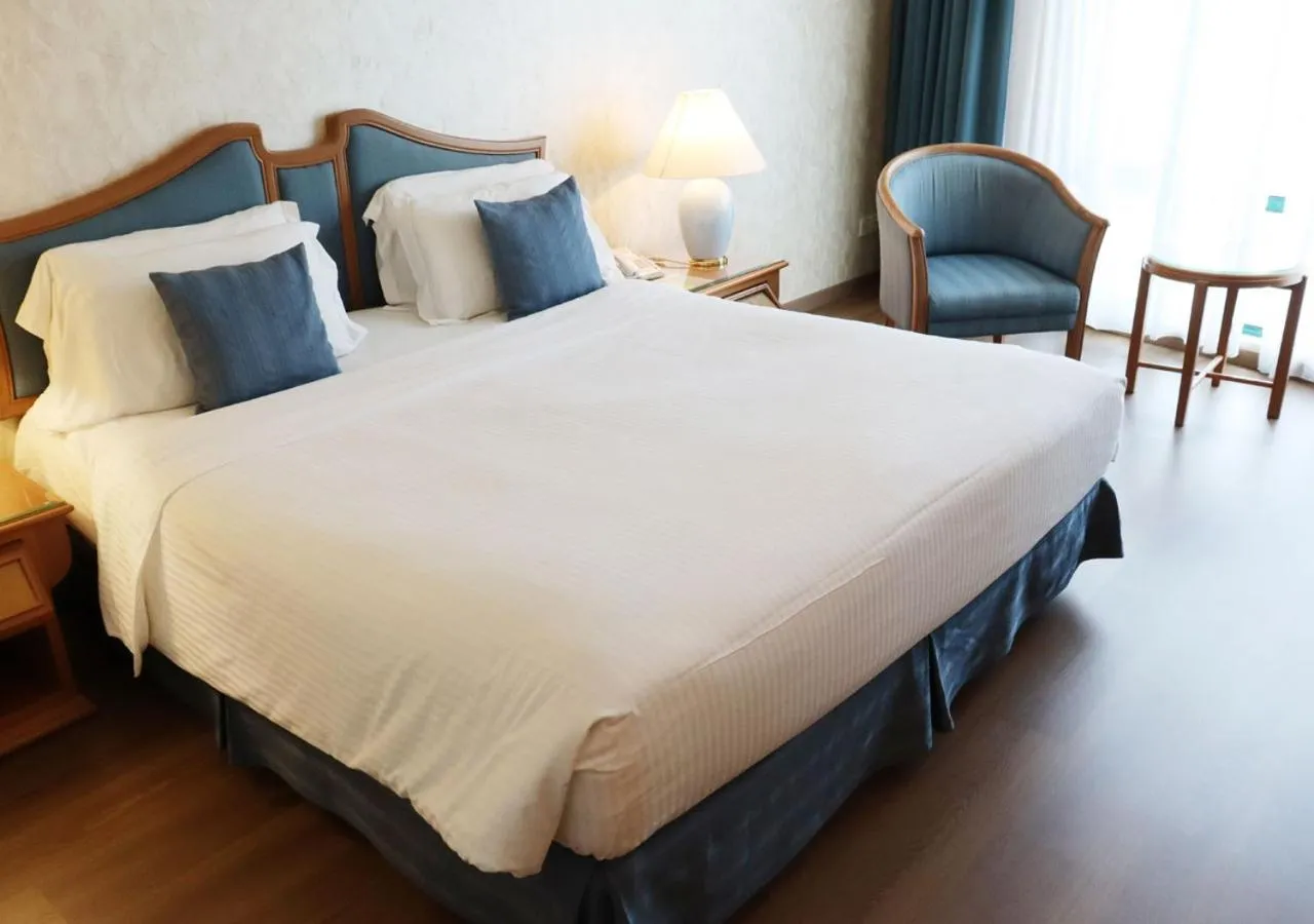 Bed in Grand Palace Hotel