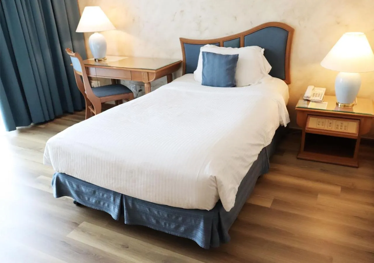 Bed in Grand Palace Hotel