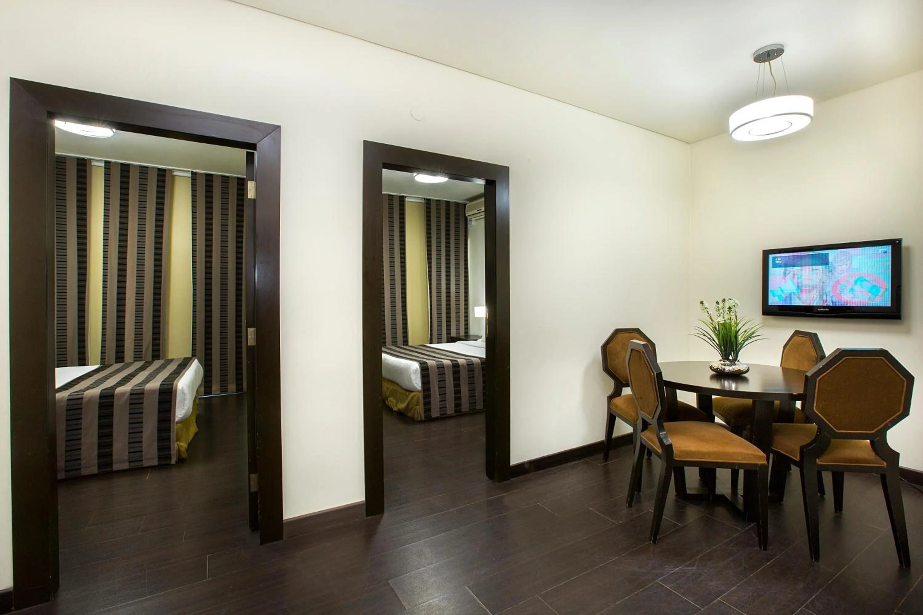 Communal lounge/ TV room, Bed in Orient Queen Homes Hotel