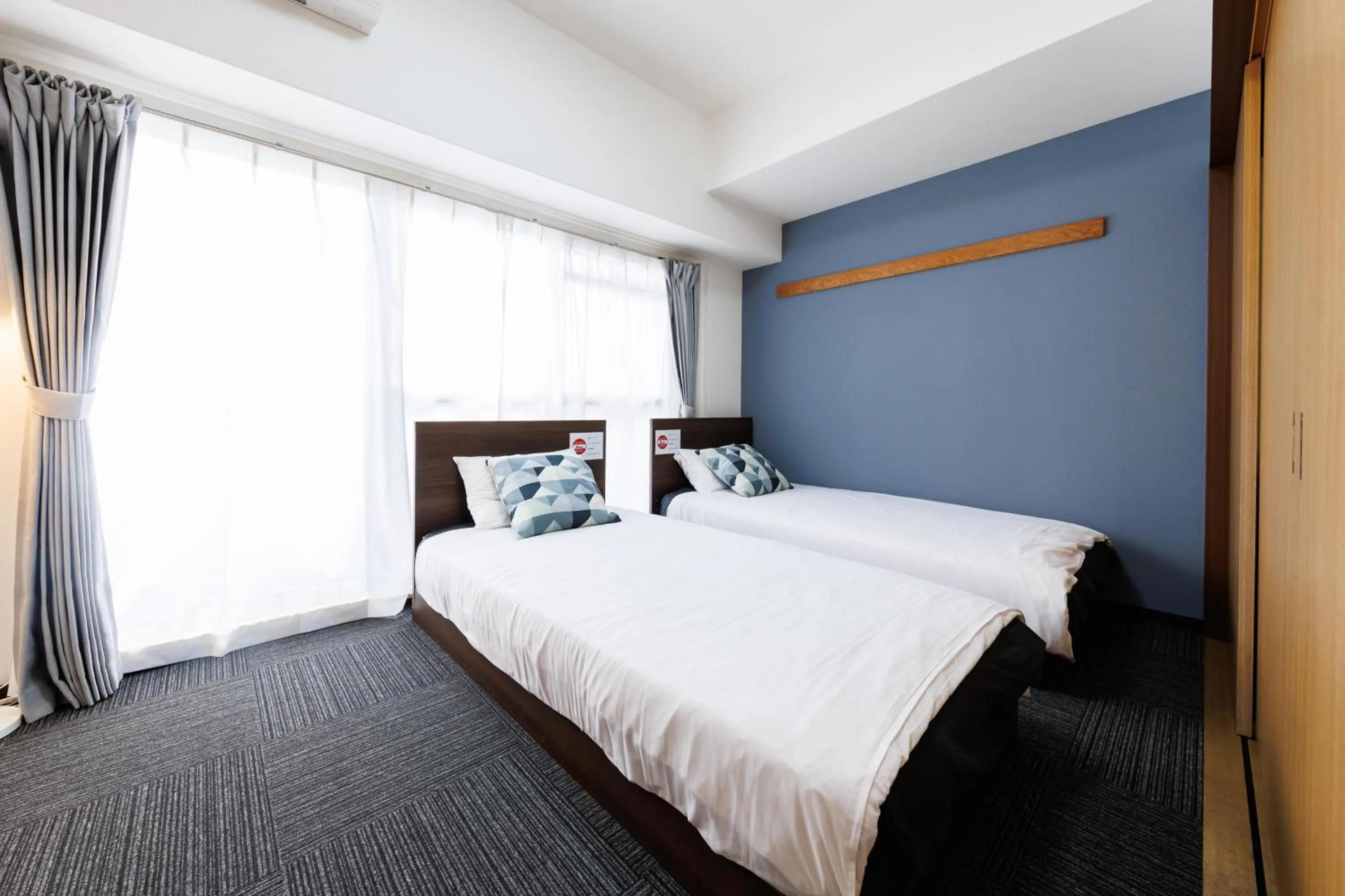 Bed in Grande Famille Shimanouchi Dotonbori Condo