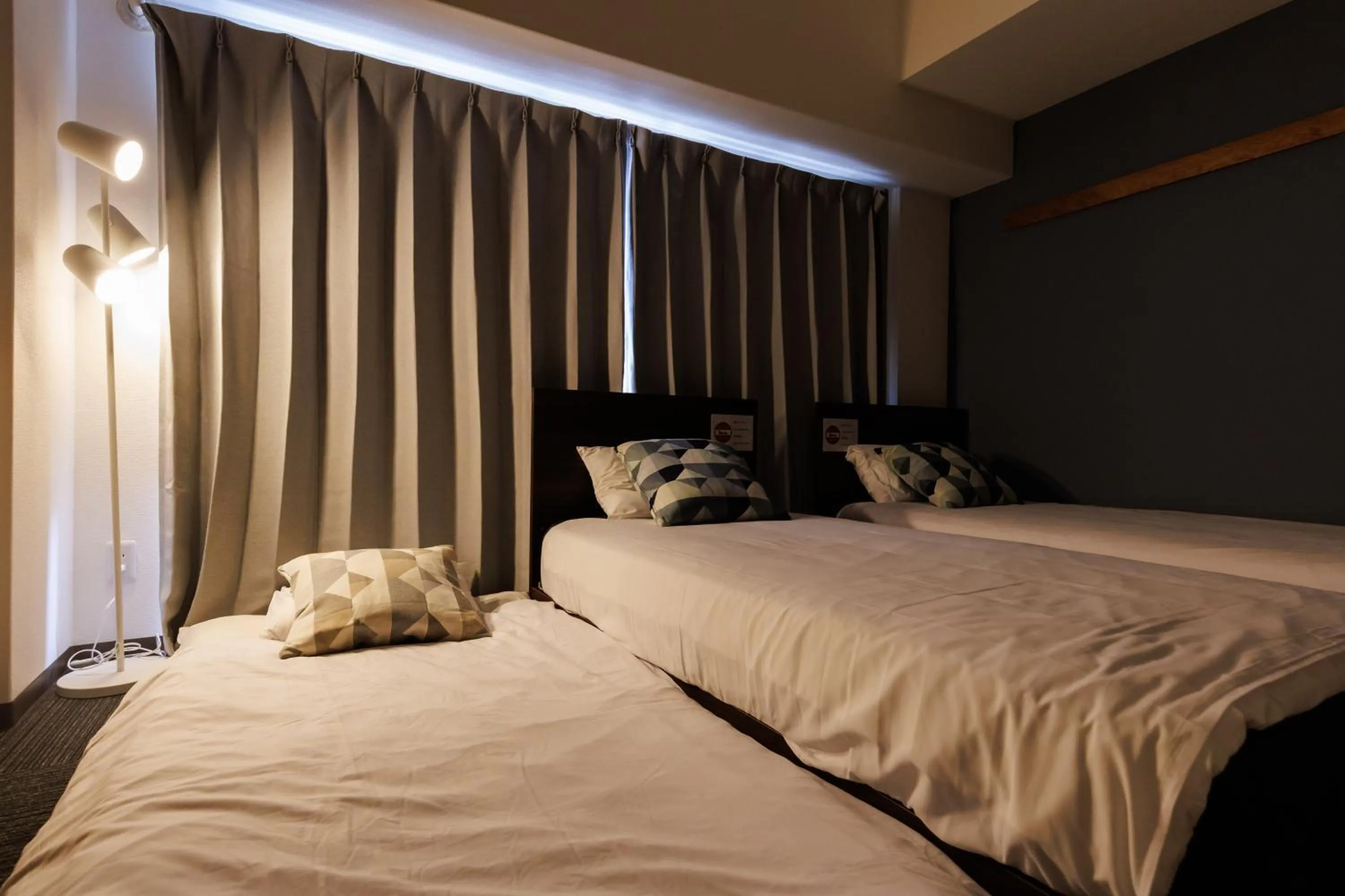 Bed in Grande Famille Shimanouchi Dotonbori Condo