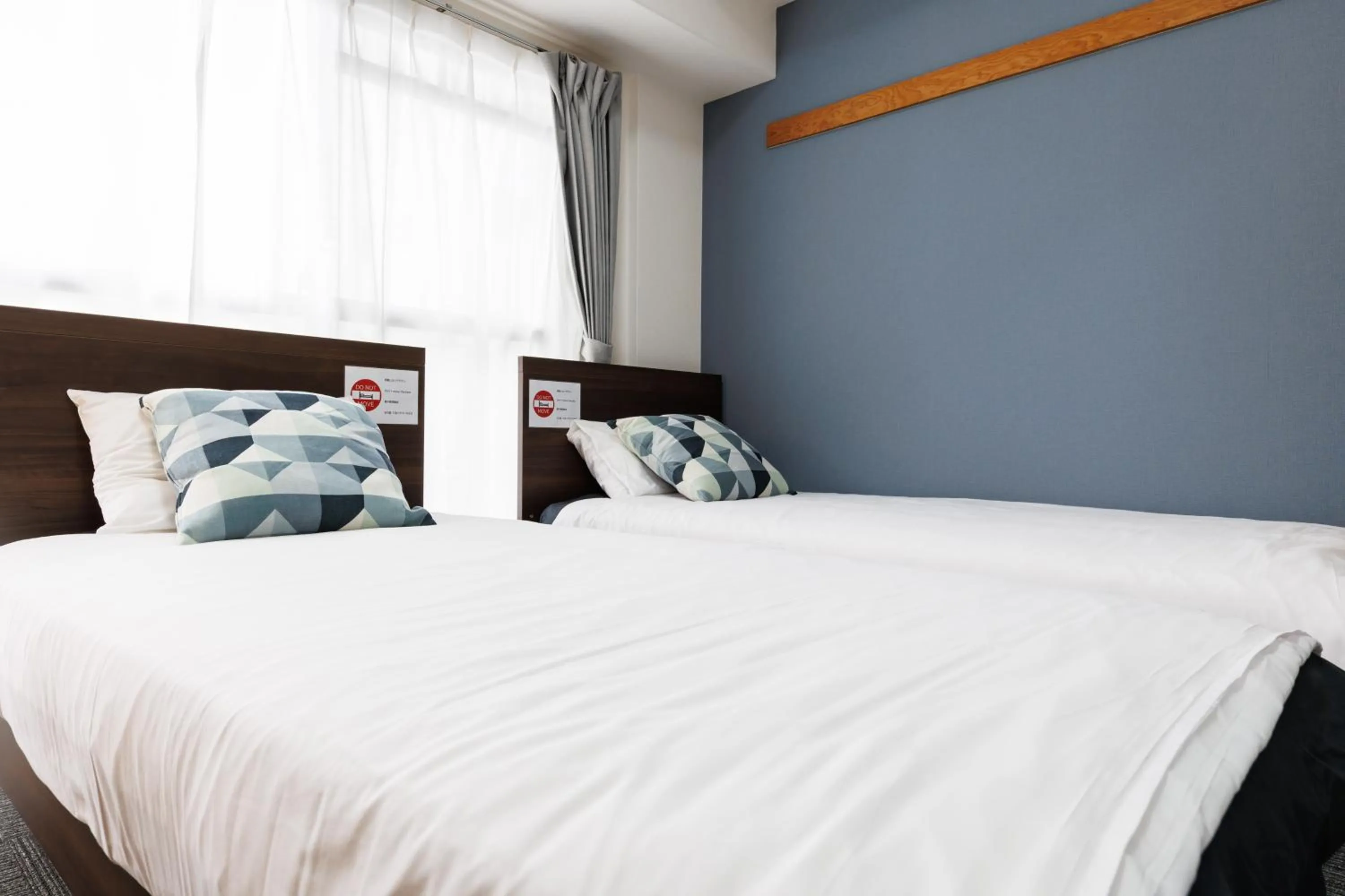 Bed in Grande Famille Shimanouchi Dotonbori Condo