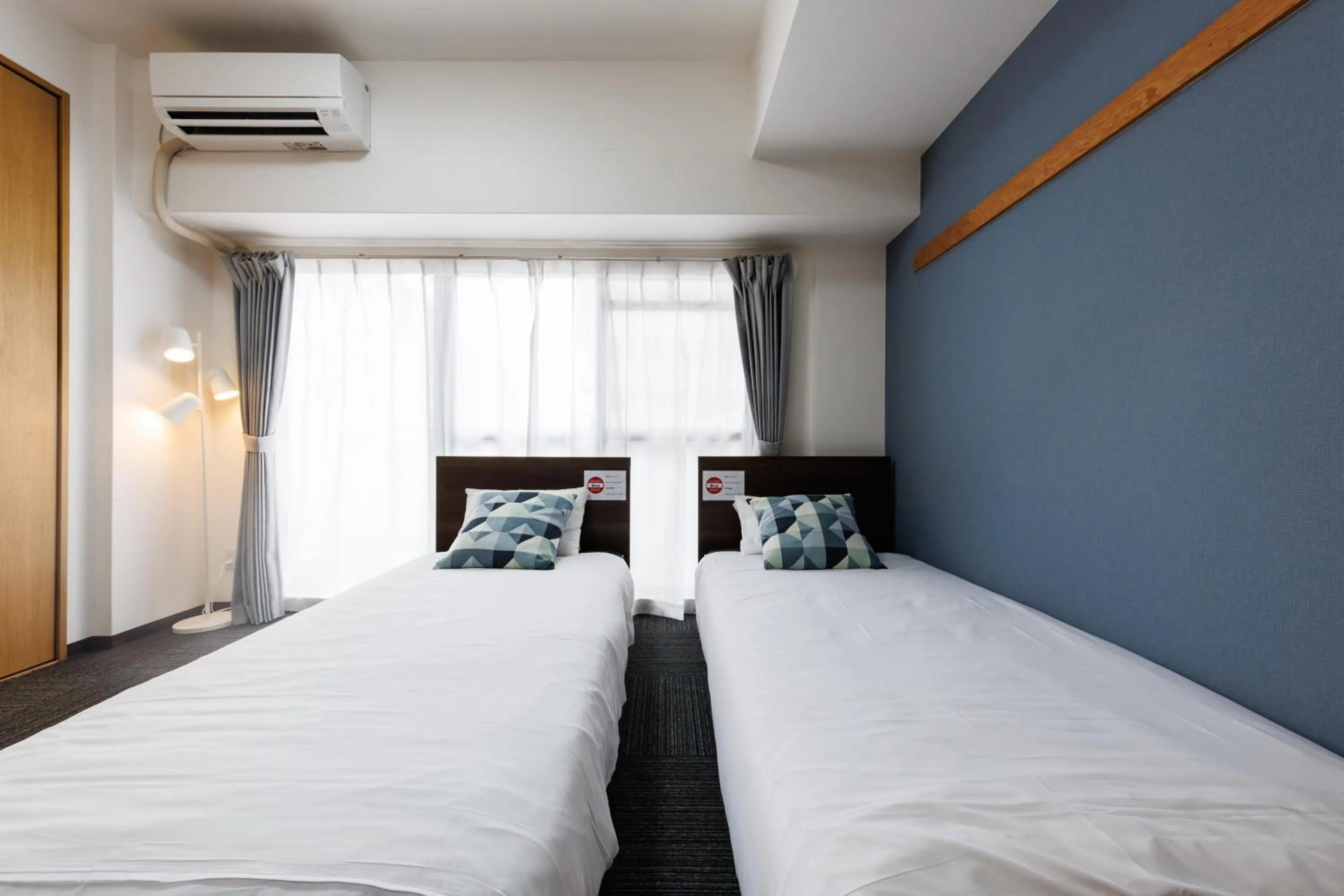 Bed in Grande Famille Shimanouchi Dotonbori Condo