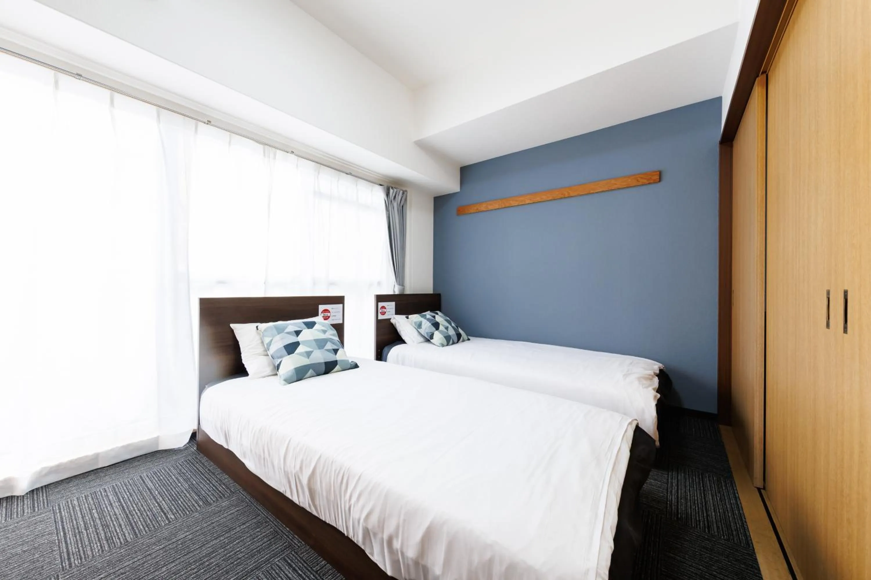 Bed in Grande Famille Shimanouchi Dotonbori Condo