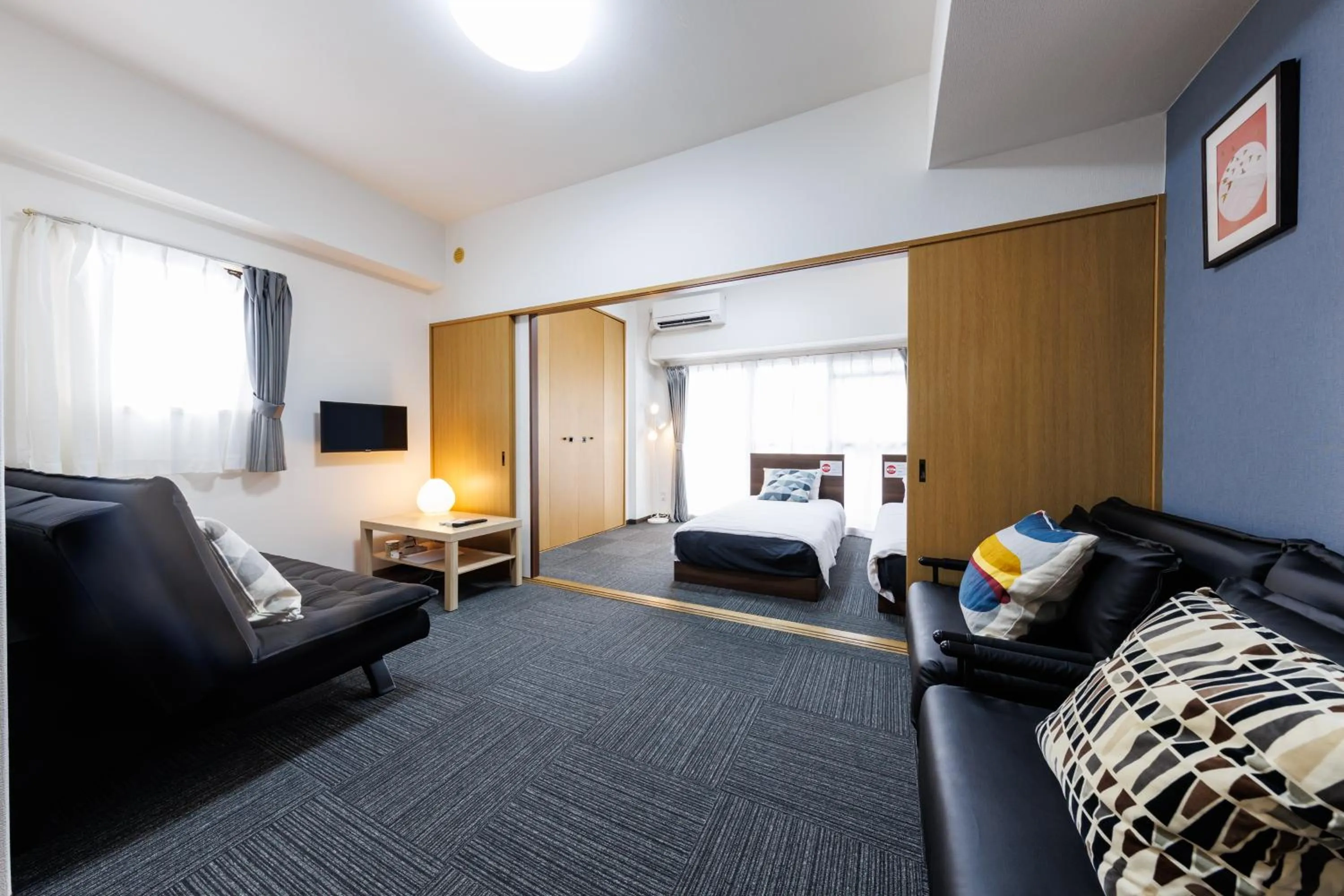 Bed in Grande Famille Shimanouchi Dotonbori Condo