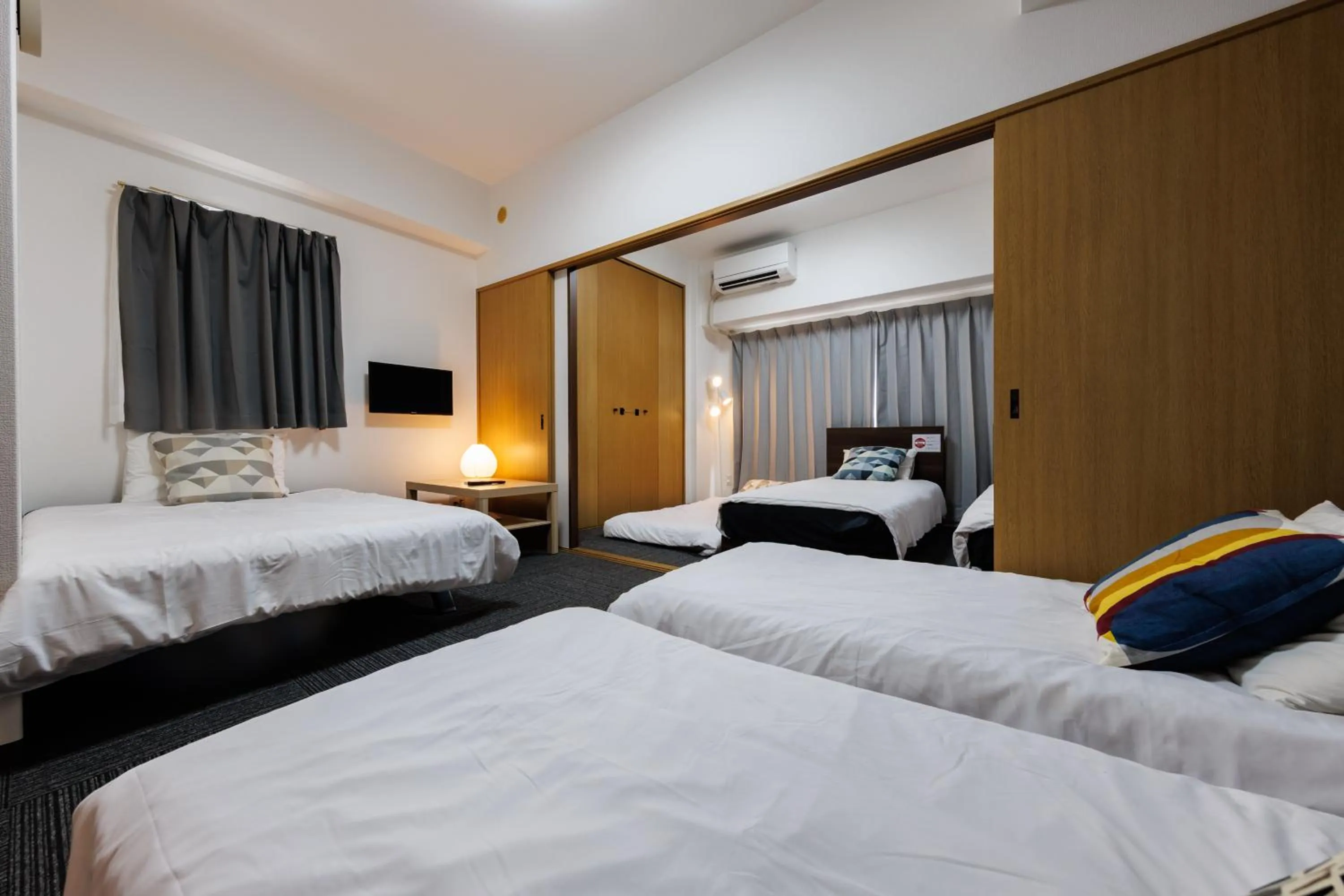 Bed in Grande Famille Shimanouchi Dotonbori Condo