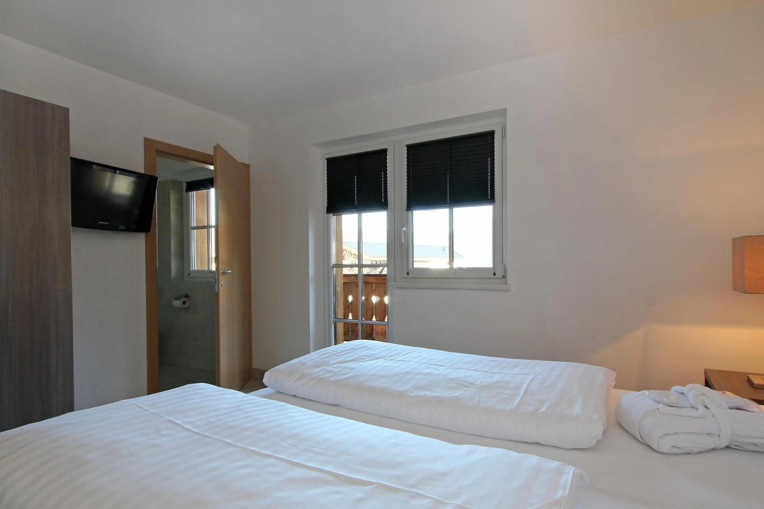 Bed in AvenidA Mountain Resort by Alpin Rentals