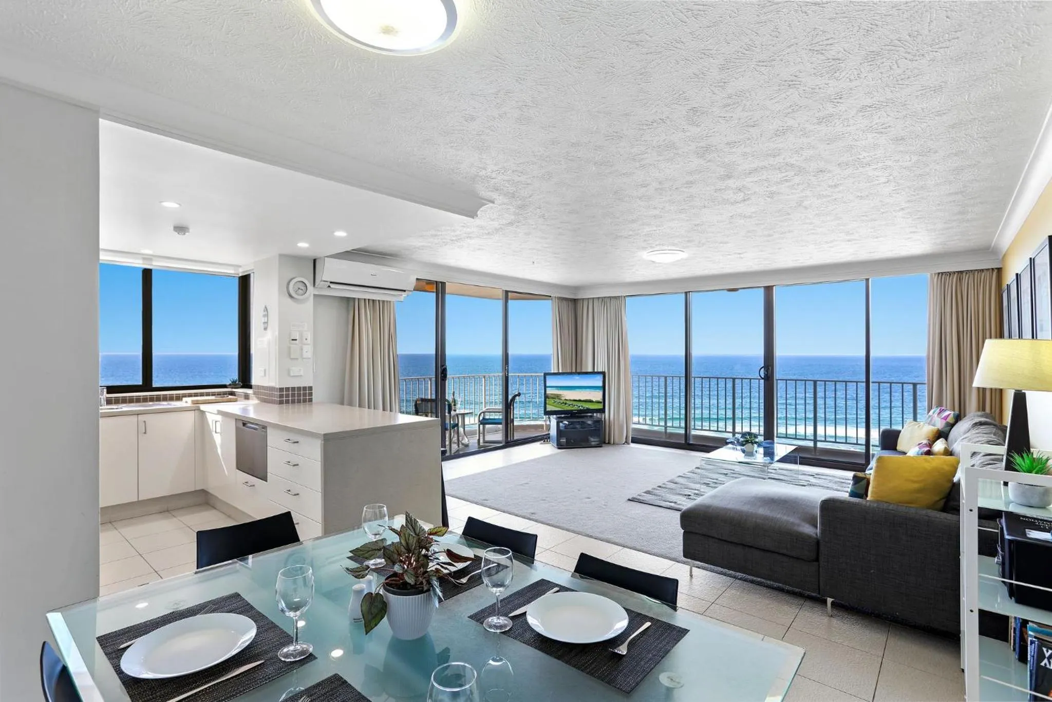 Living room, Bed in Breakers North Absolute Beachfront Apartments - Official