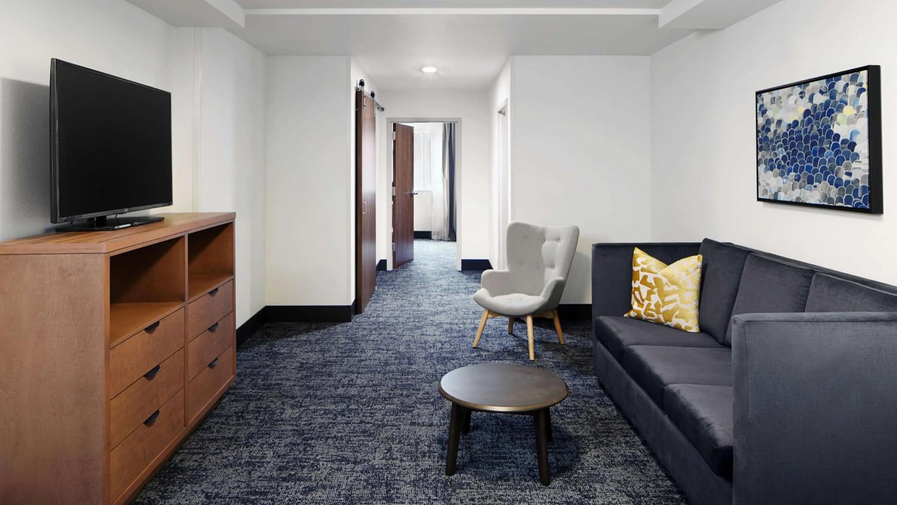 Living room in River's Edge Hotel Portland, Tapestry Collection by Hilton