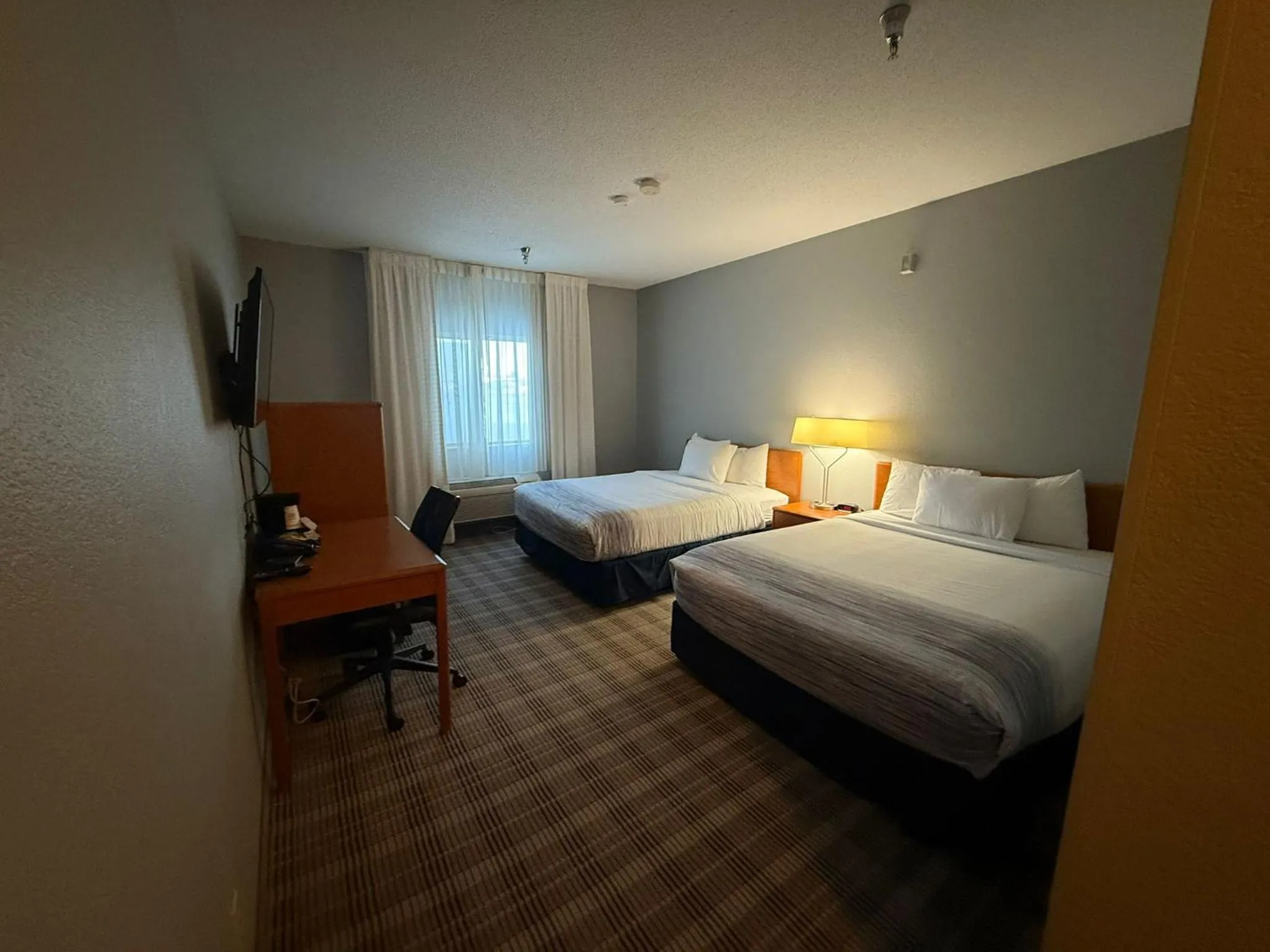 Bed in AmericInn by Wyndham Minot
