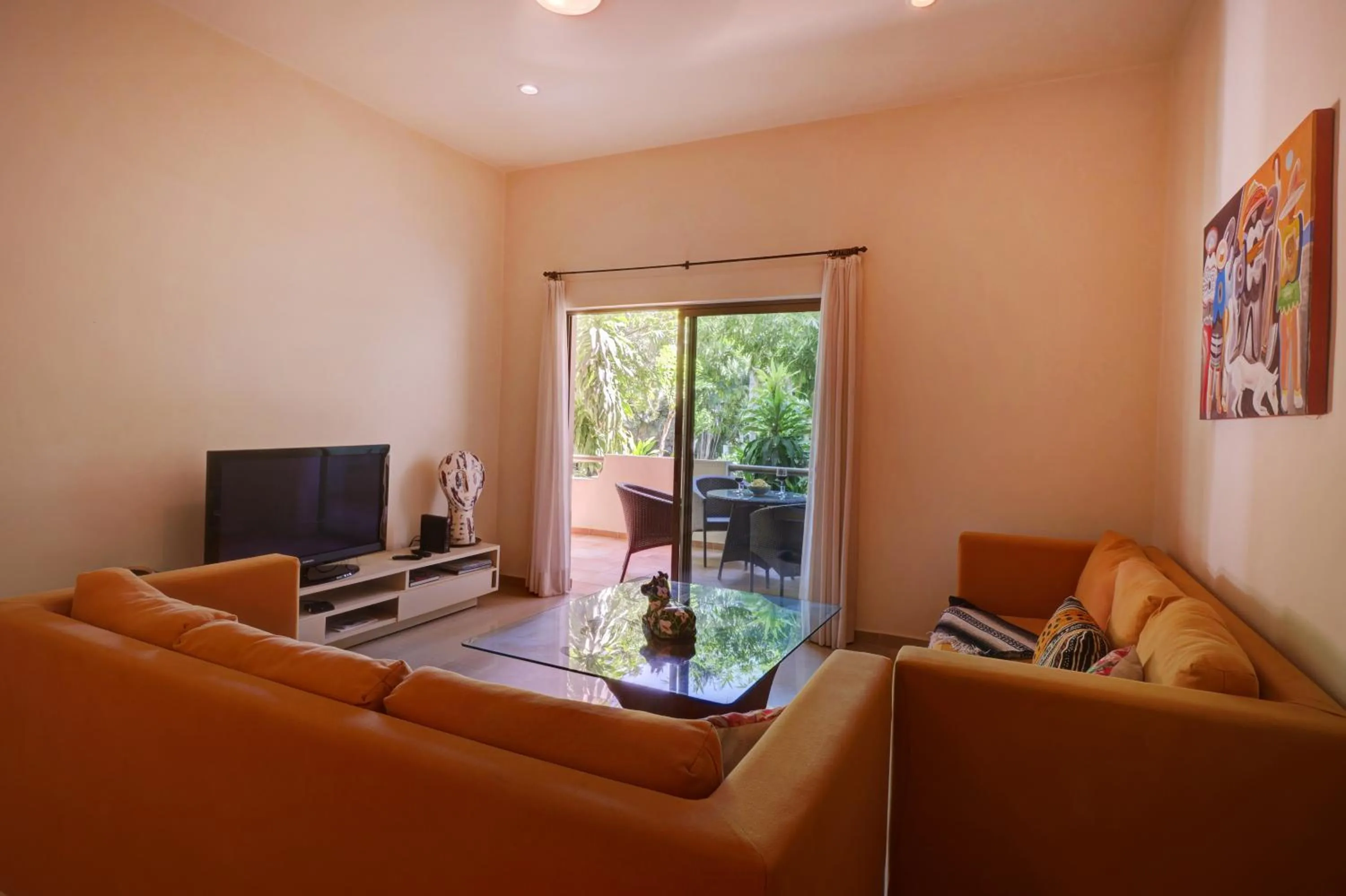 Communal lounge/ TV room in Riviera Maya Suites