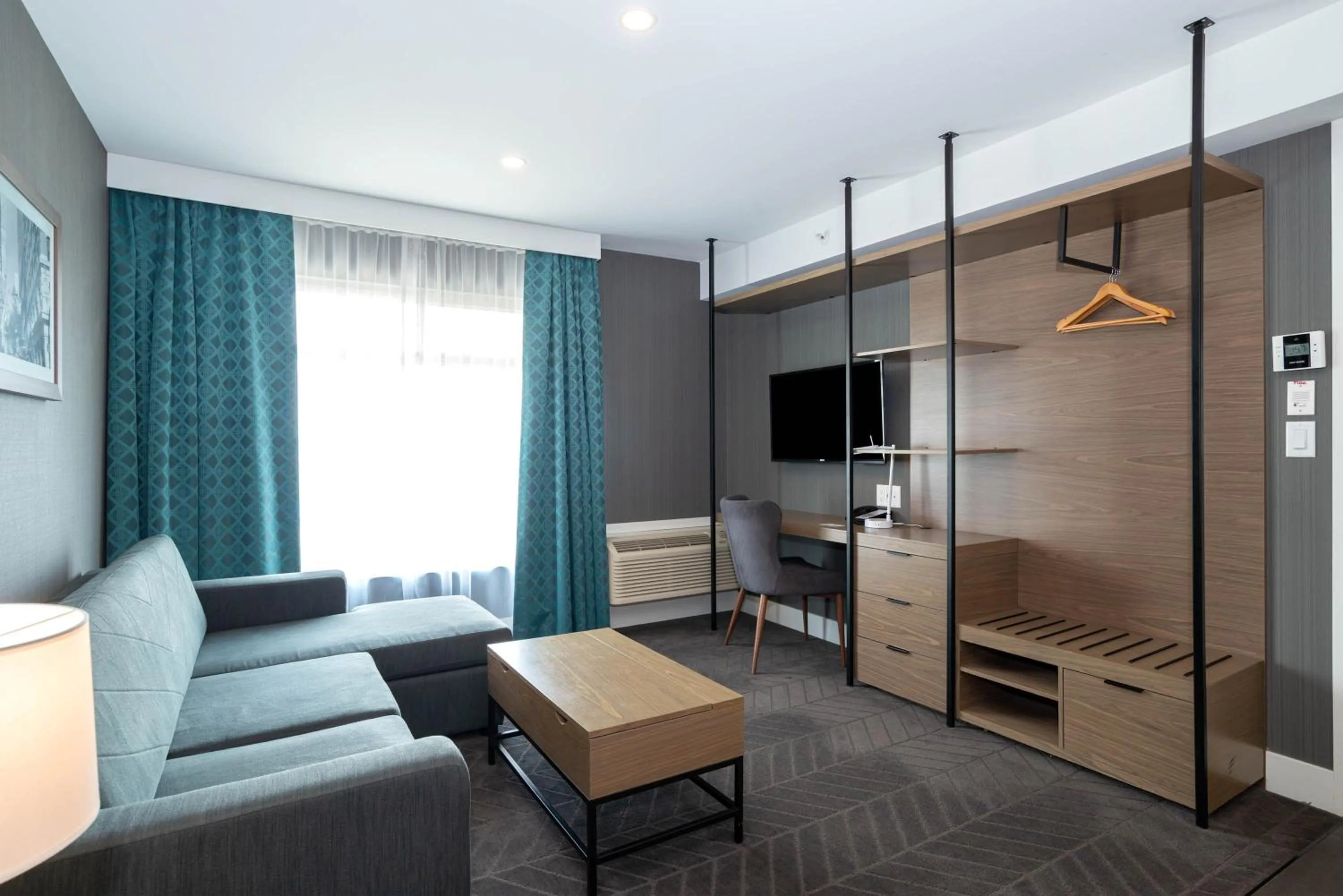 Living room, Bed in Sandman Signature Calgary Airport Hotel