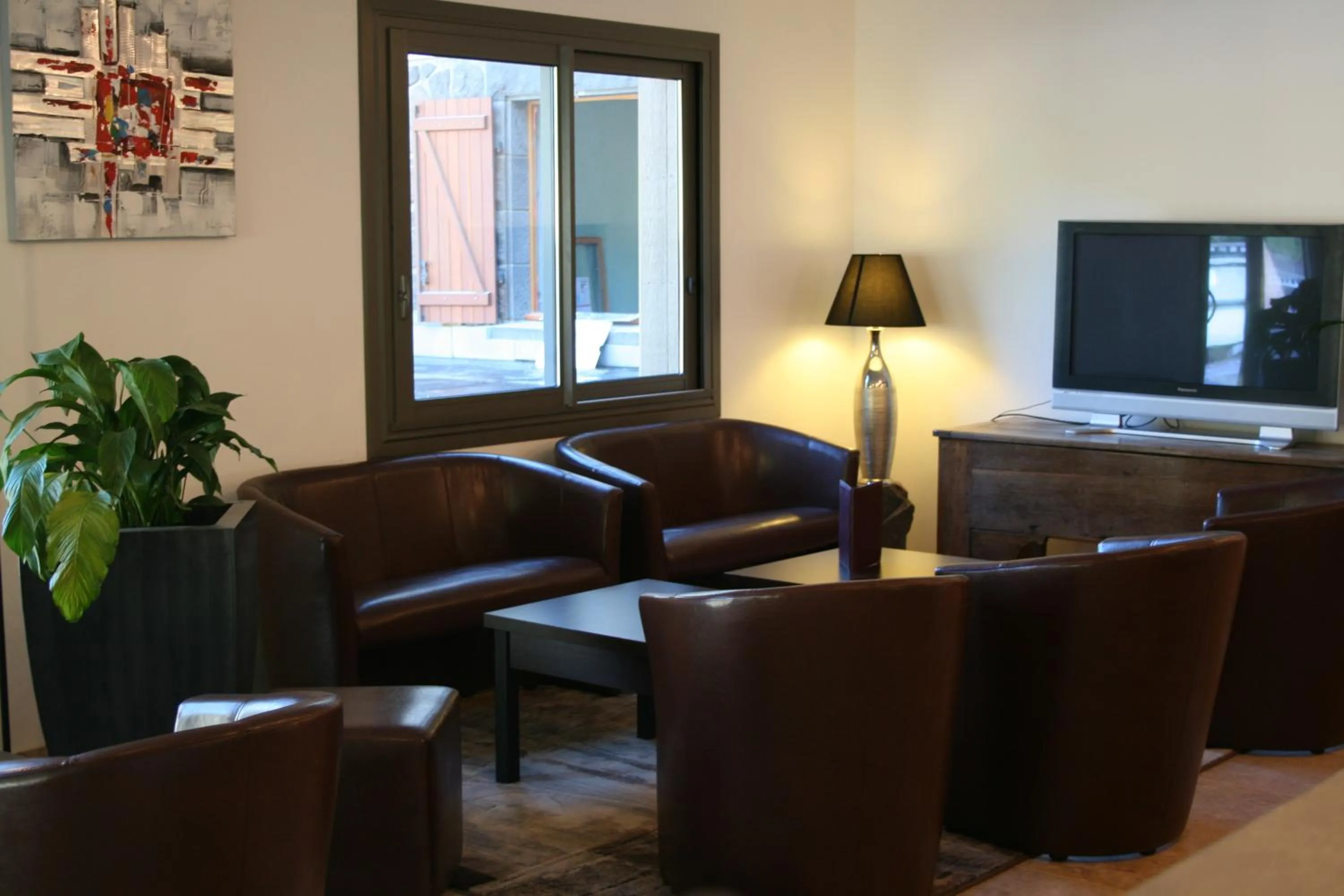 Communal lounge/ TV room in Auberge de la Petite Ferme, Super-Besse Est, The Originals Relais