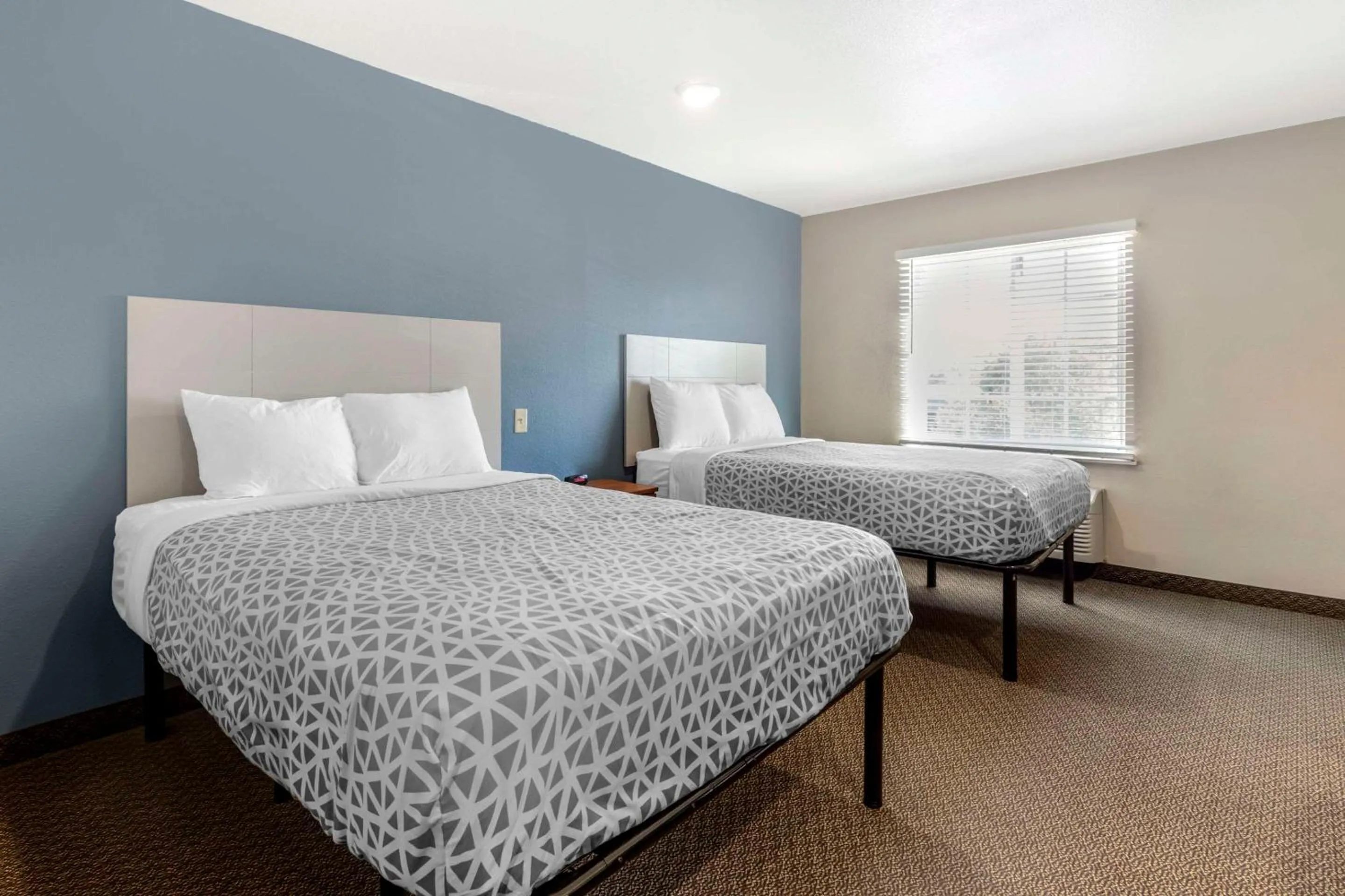 Bedroom, Bed in WoodSpring Suites Raleigh Garner