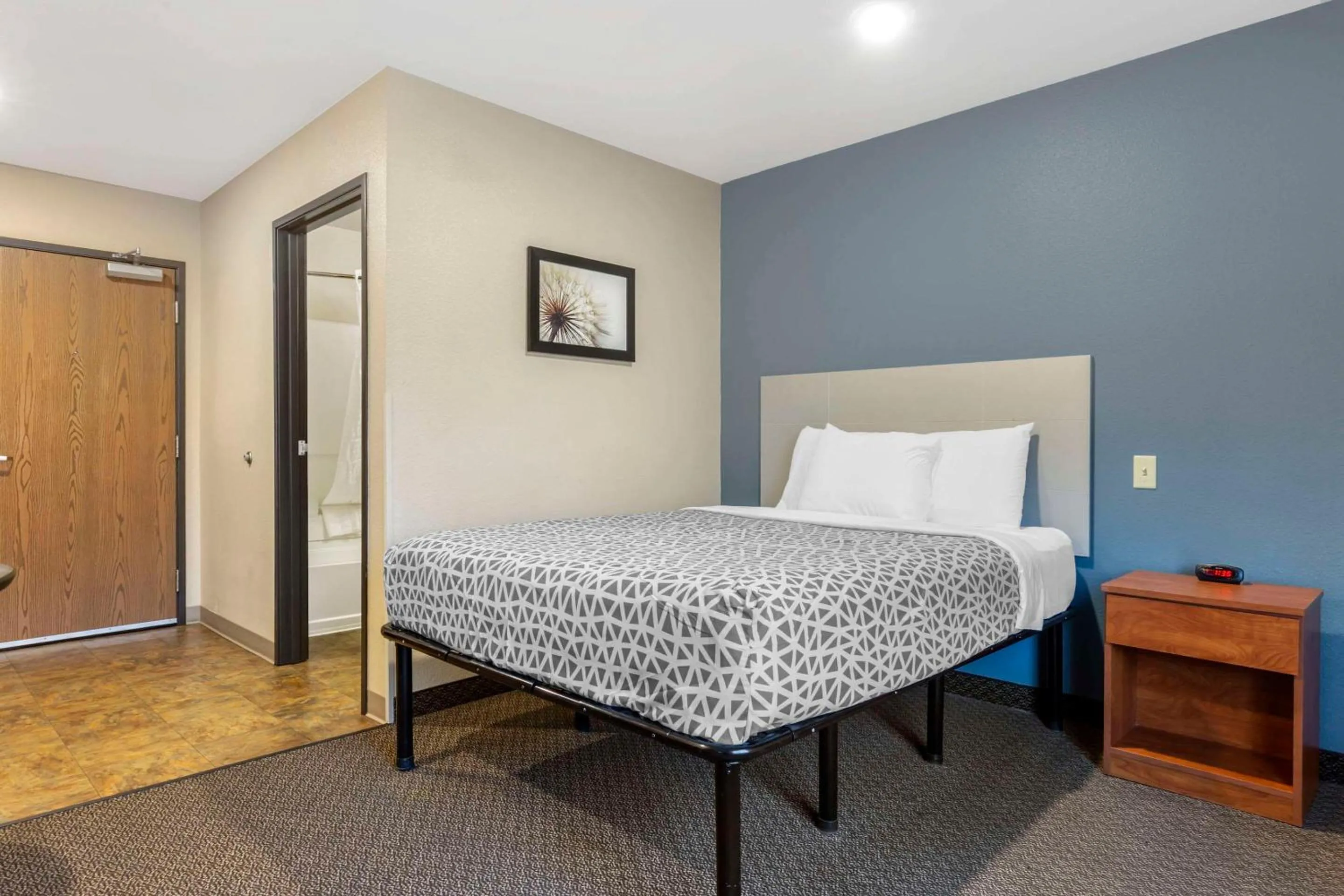 Bedroom, Bed in WoodSpring Suites Raleigh Garner