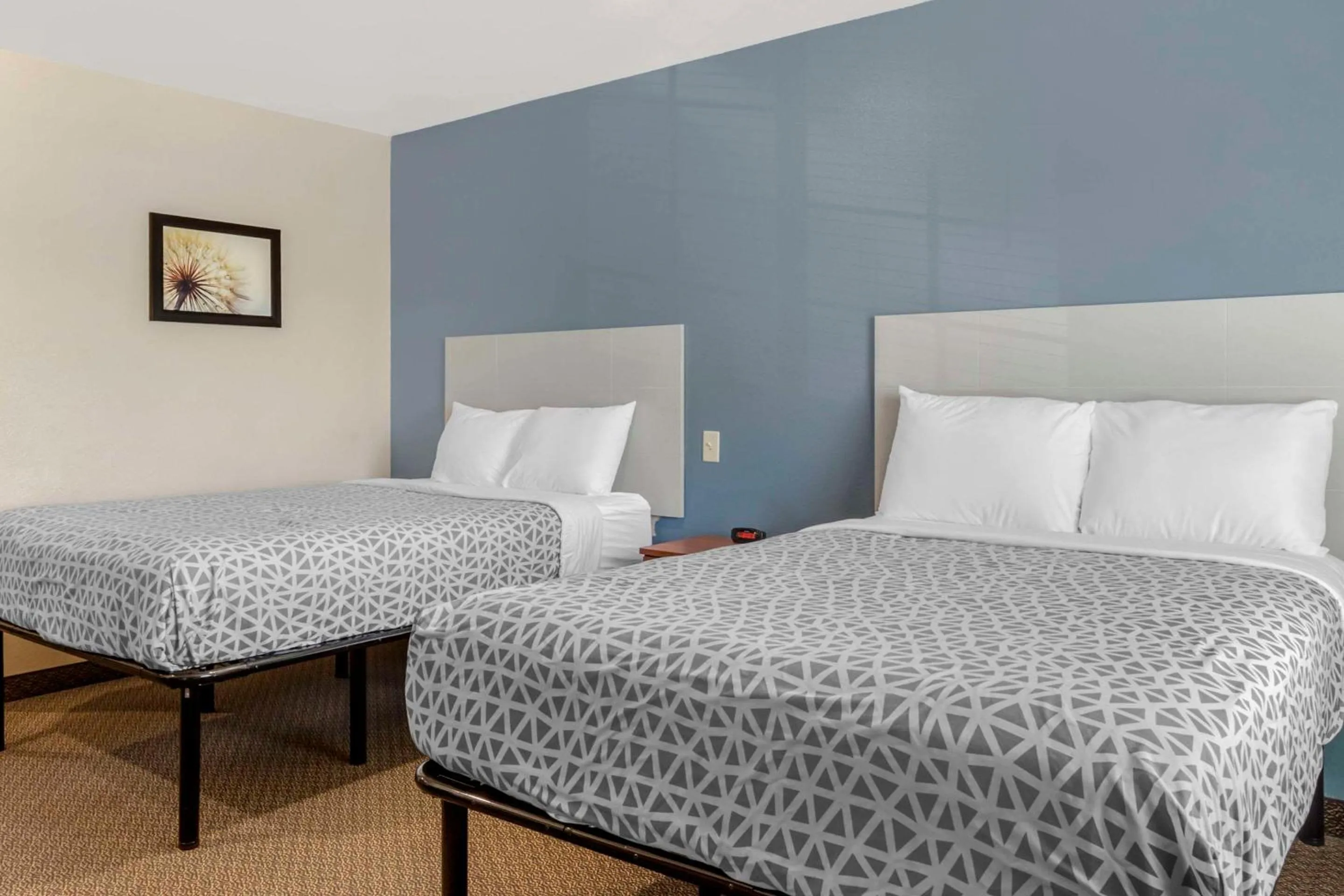 Bedroom, Bed in WoodSpring Suites Raleigh Garner