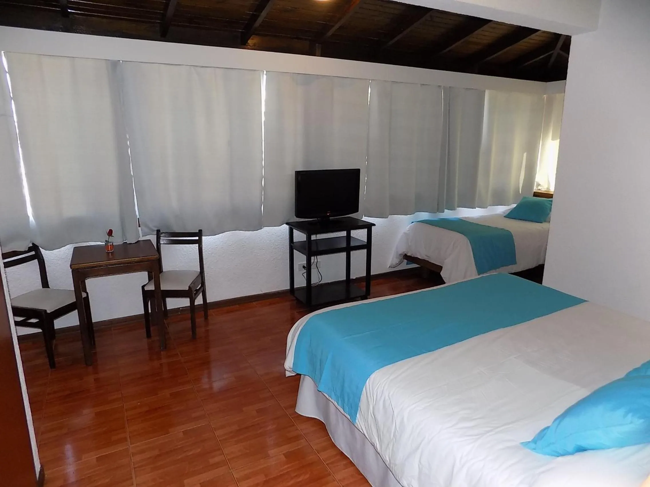 Communal lounge/ TV room, Bed in Hotel Concorde