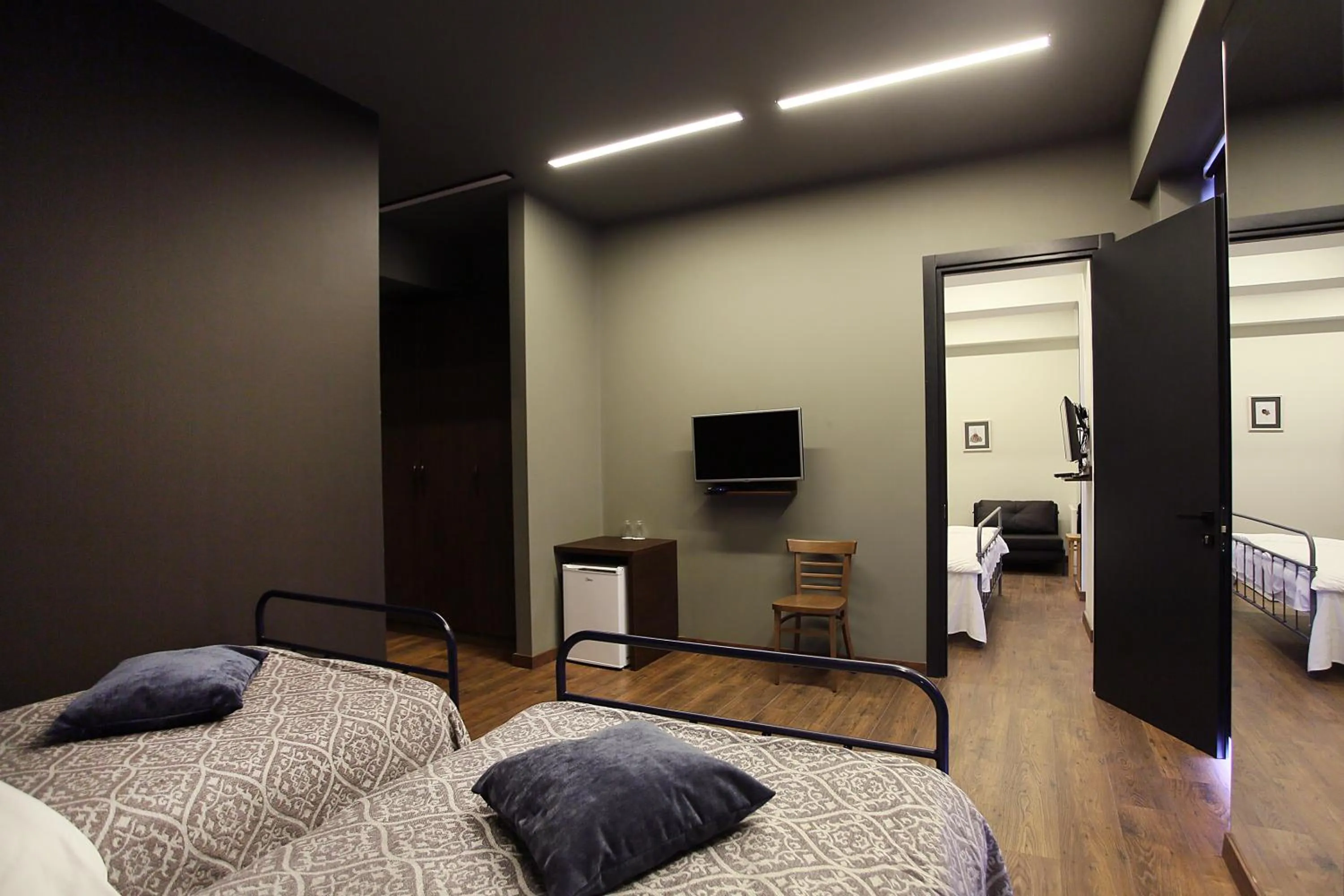 Communal lounge/ TV room, Bed in L.M Club Hotel