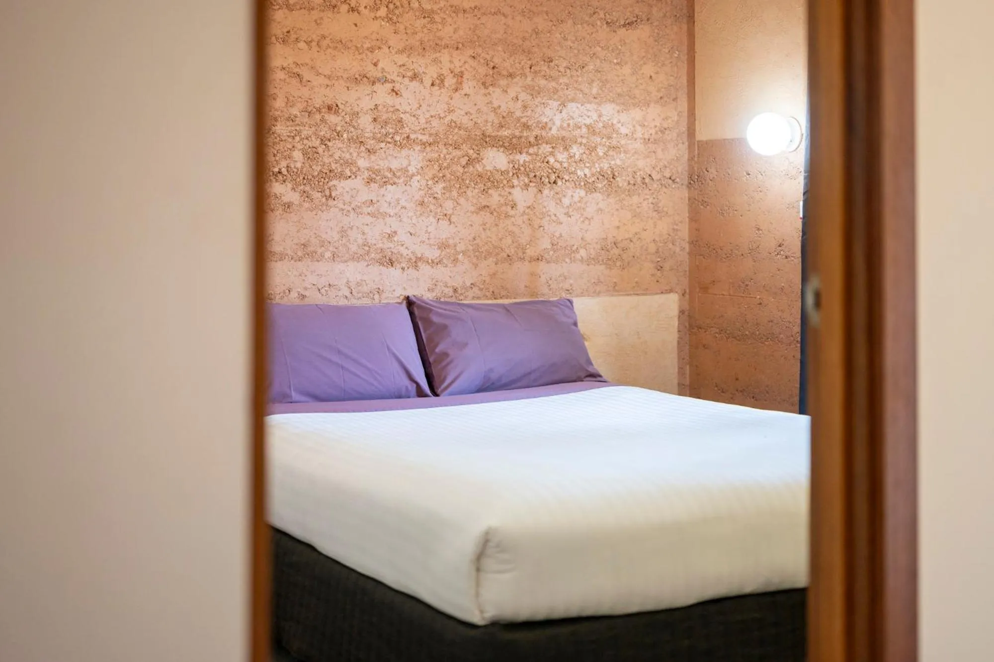 Bed in Mud Hut Motel