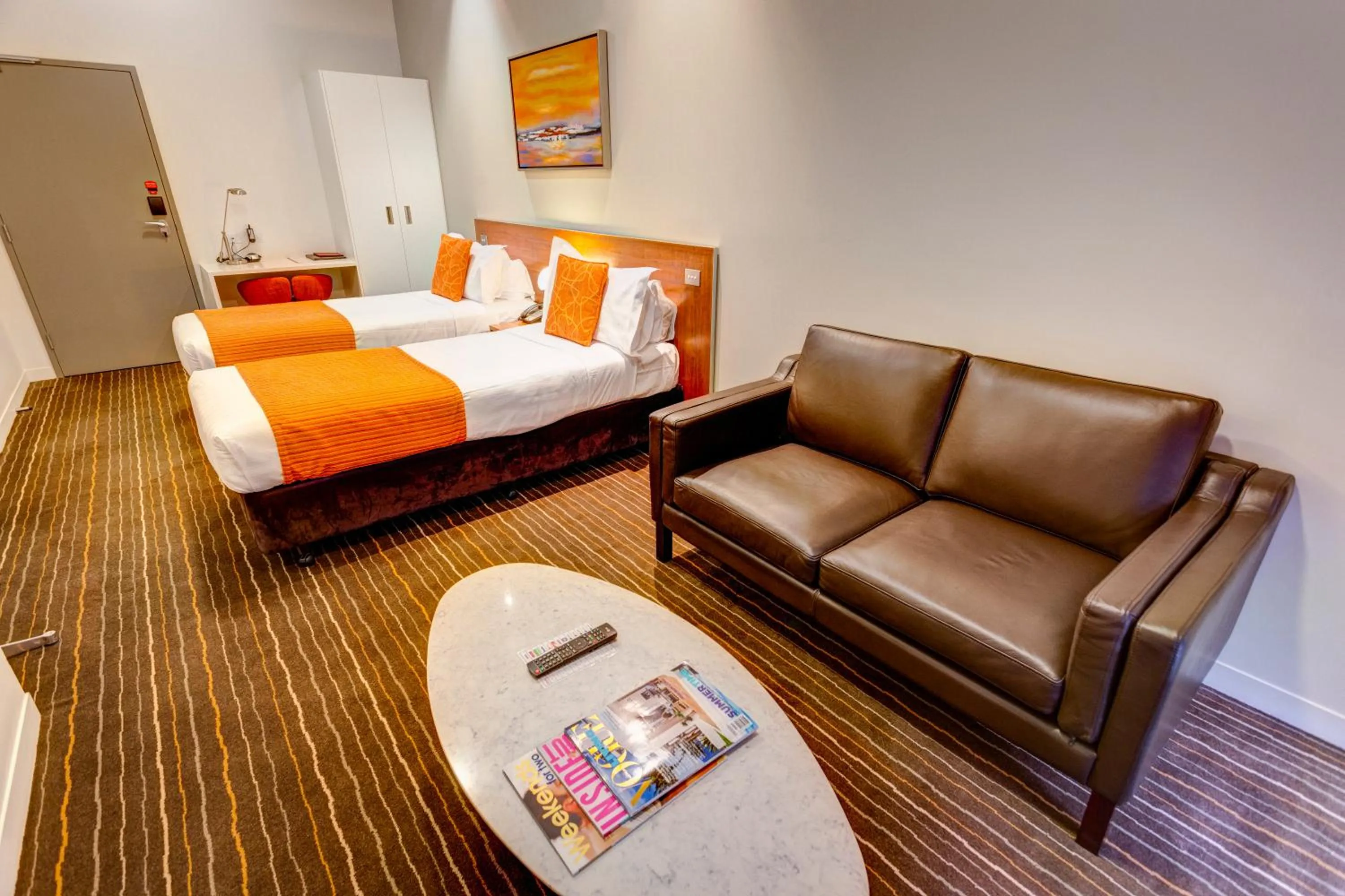 Seating area, Bed in Mantra Charles Hotel