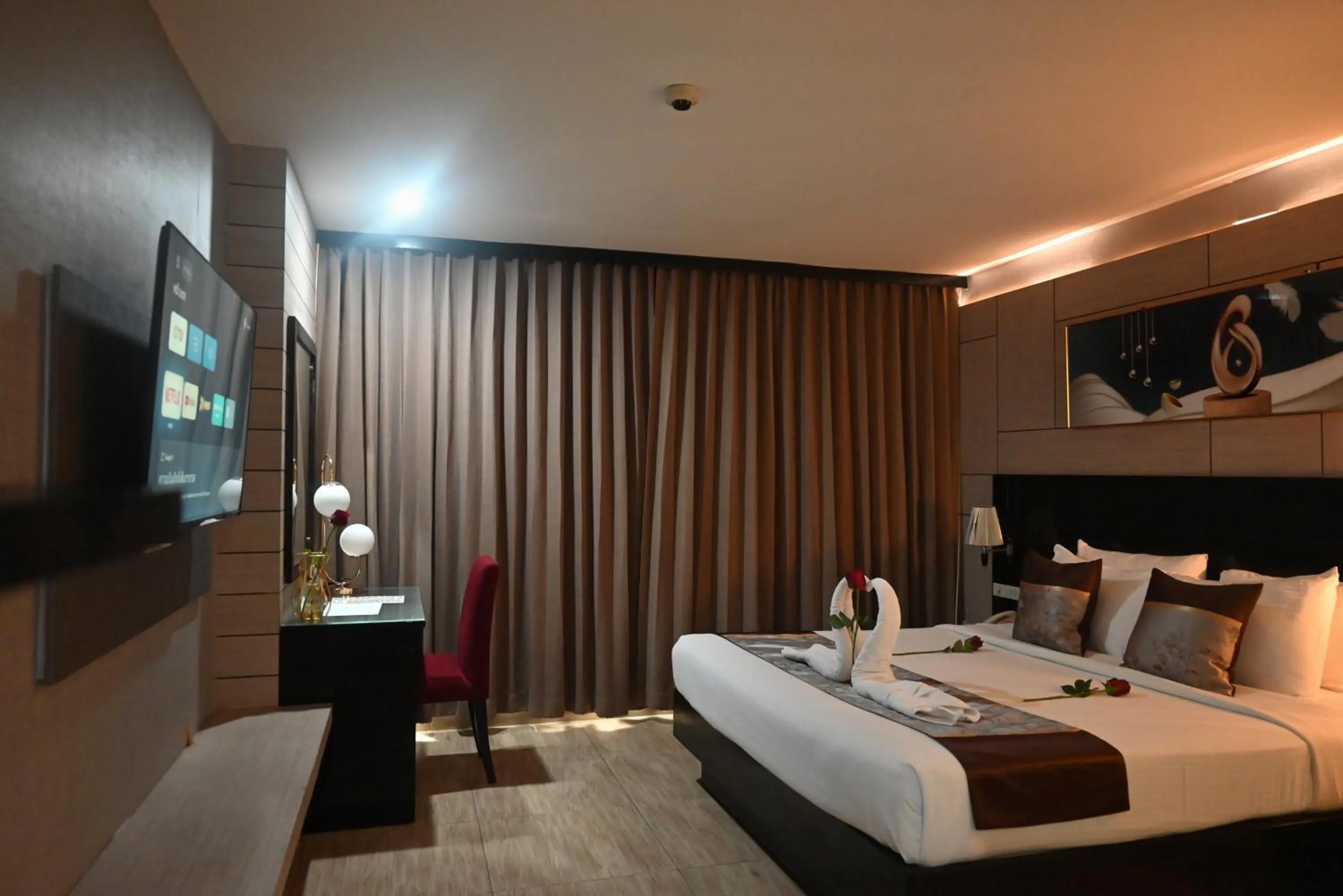 Bed in Boss Suites Nana Hotel