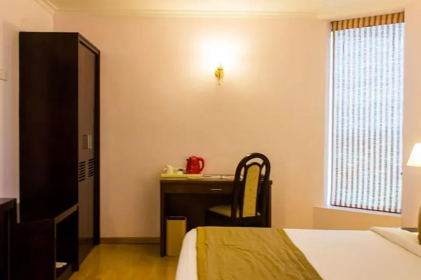 Seating area, Bed in The Quilon Beach Hotel and Convention Center