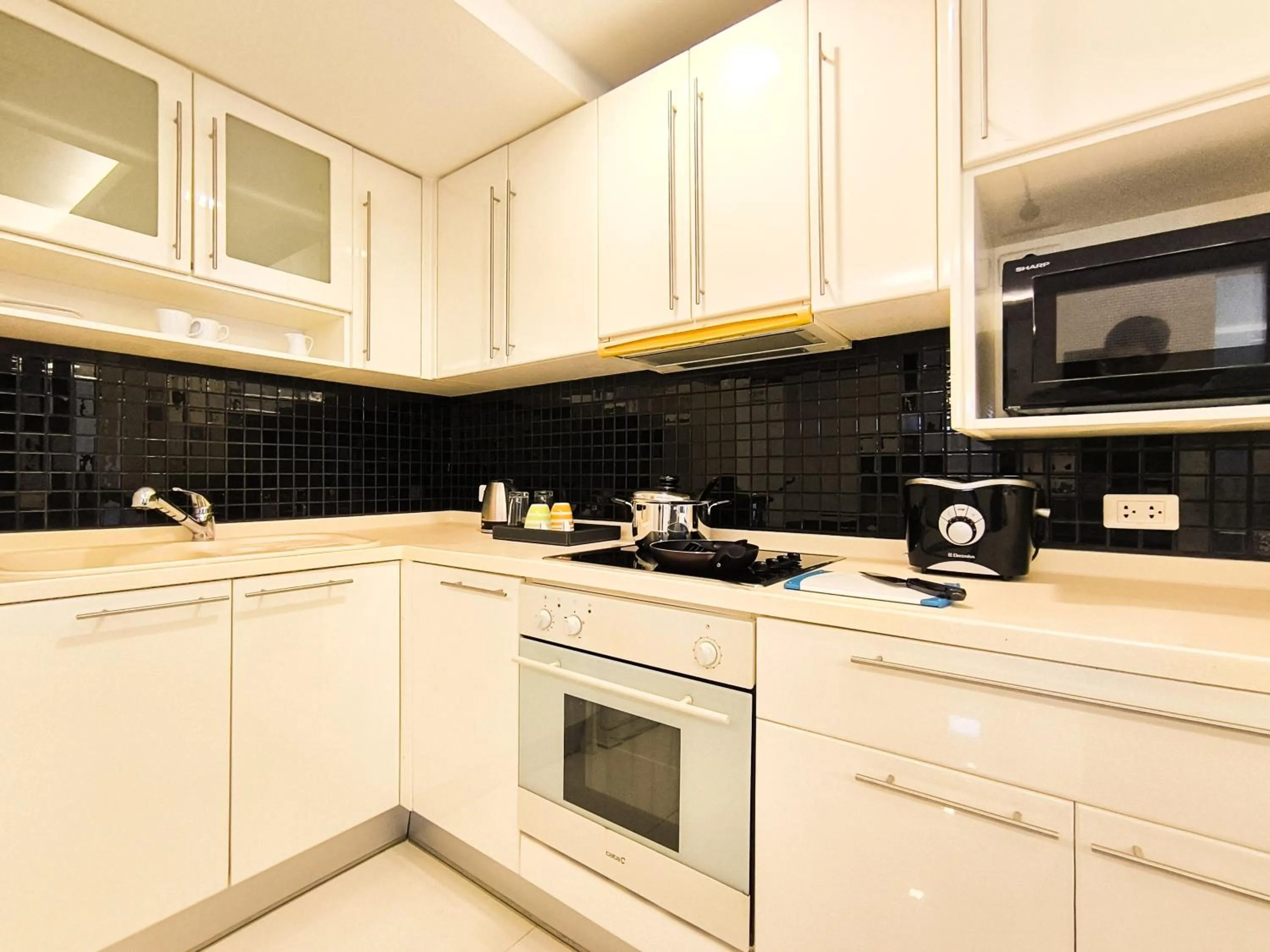 Kitchen or kitchenette in Nova Suites Pattaya by Compass Hospitality
