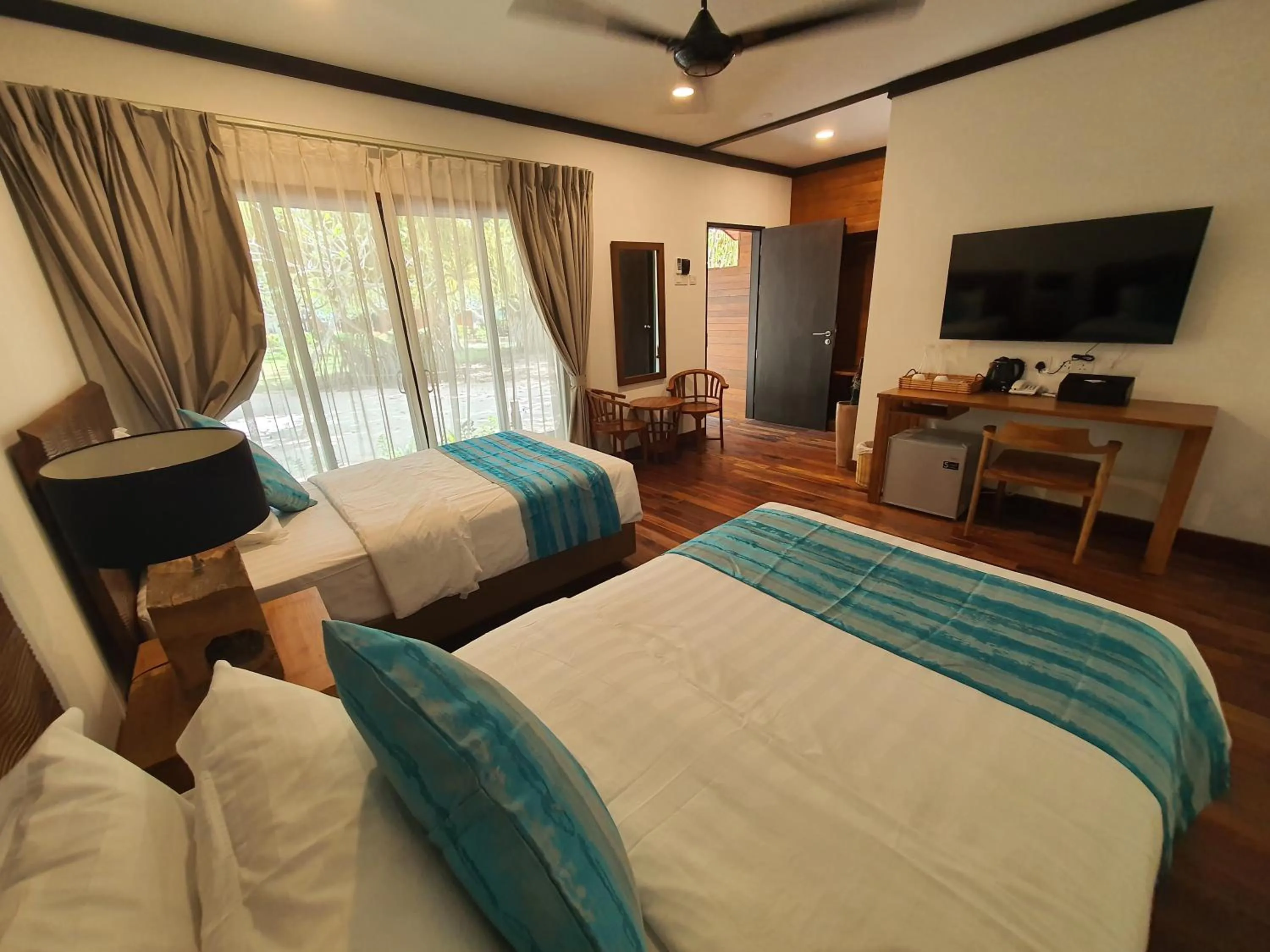 Bed in Borneo Divers Mabul Resort