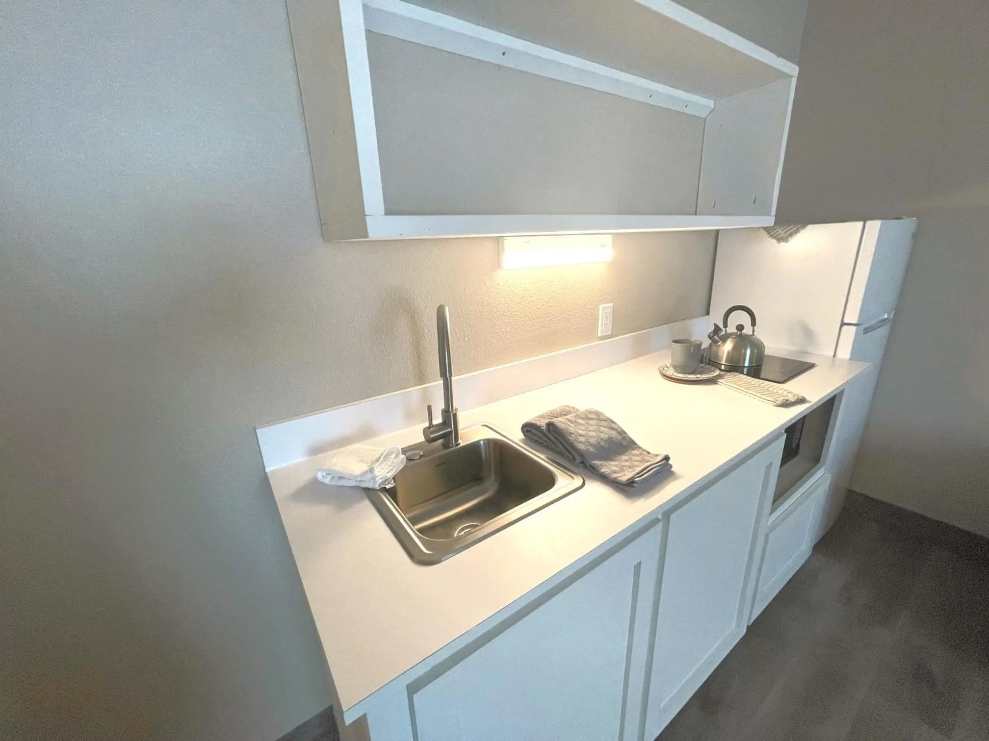 Kitchen or kitchenette in FairBridge Extended Stay, a Kitchenette Hotel