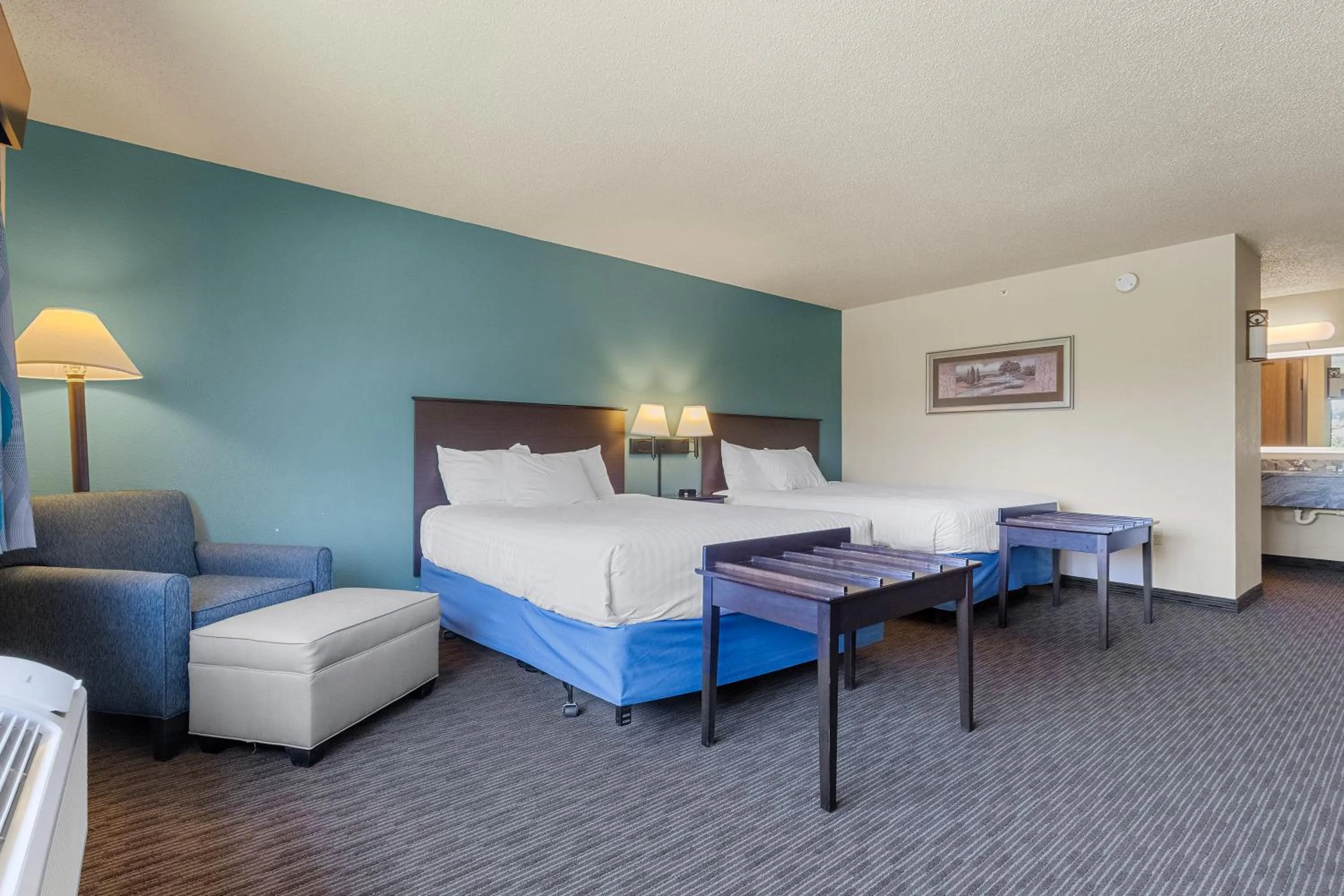 Seating area, Bed in AmericInn by Wyndham Green Bay East