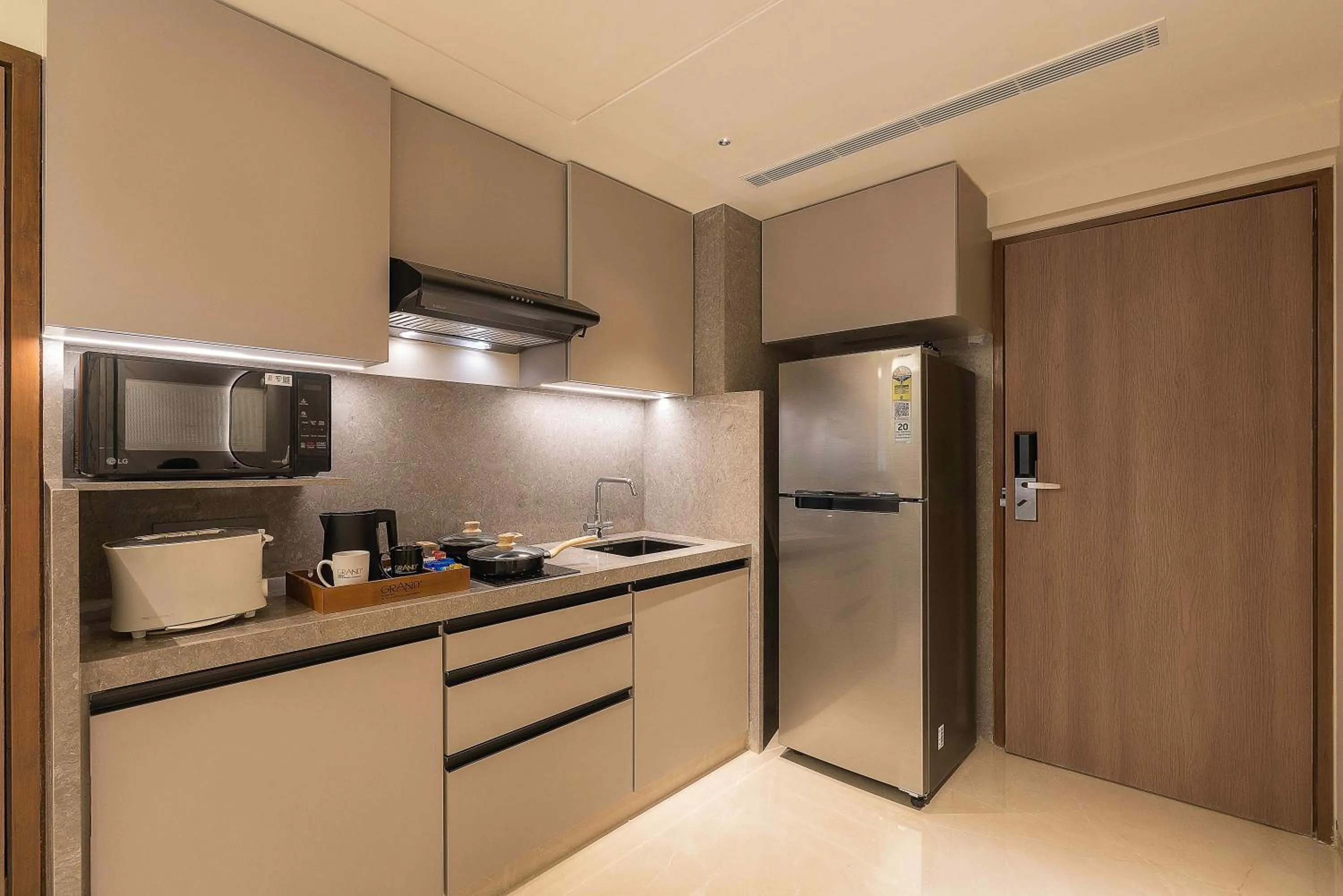 Kitchen or kitchenette in Grand Residency Hotel & Serviced Apartments