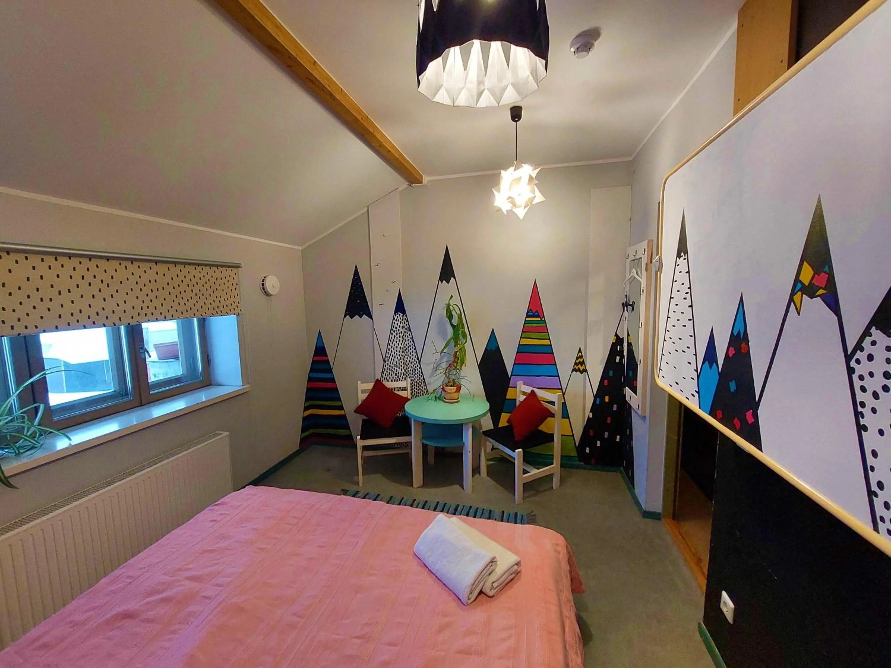 Seating area, Bed in Looming Hostel