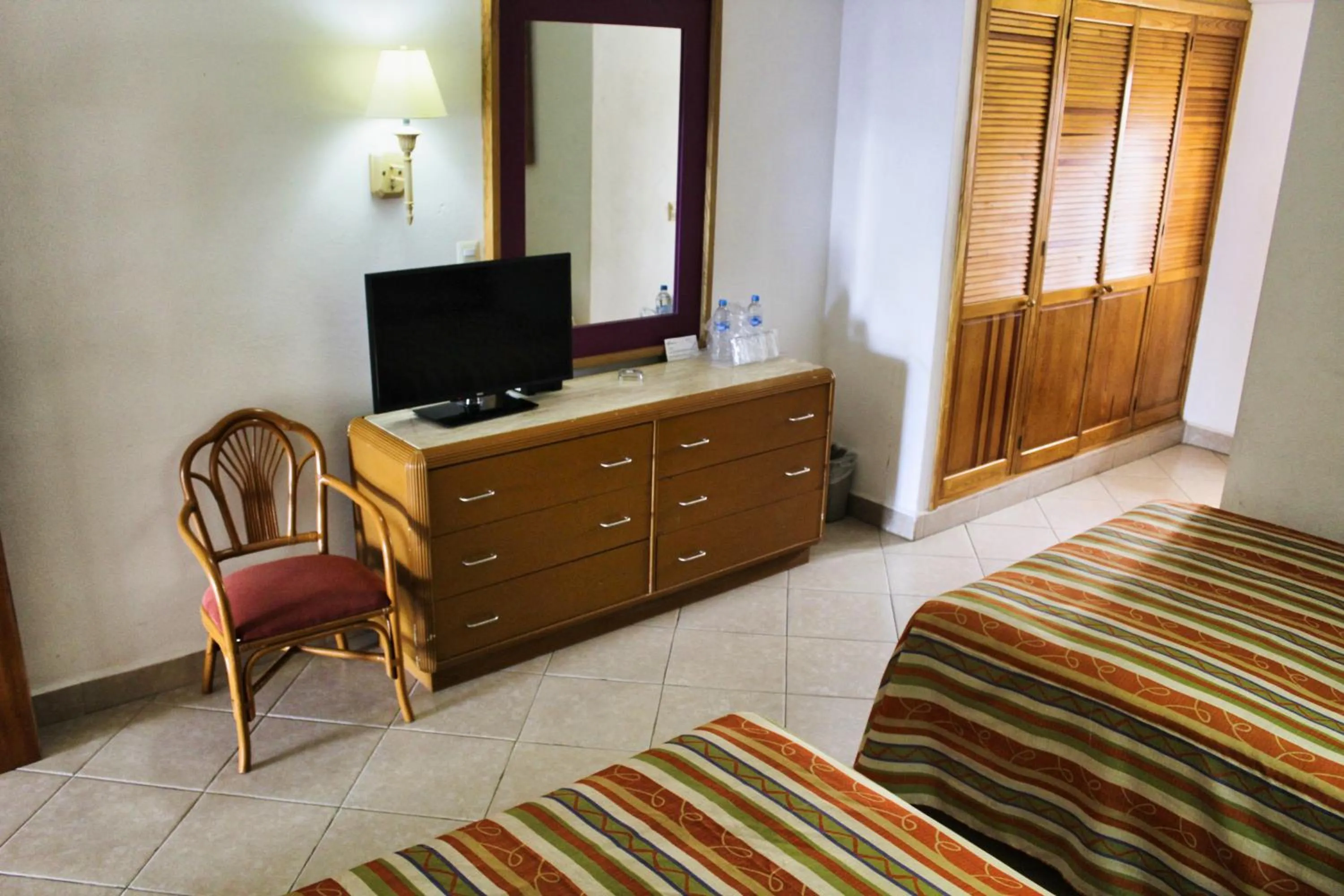 Communal lounge/ TV room, Bed in Tropicana Hotel Puerto Vallarta