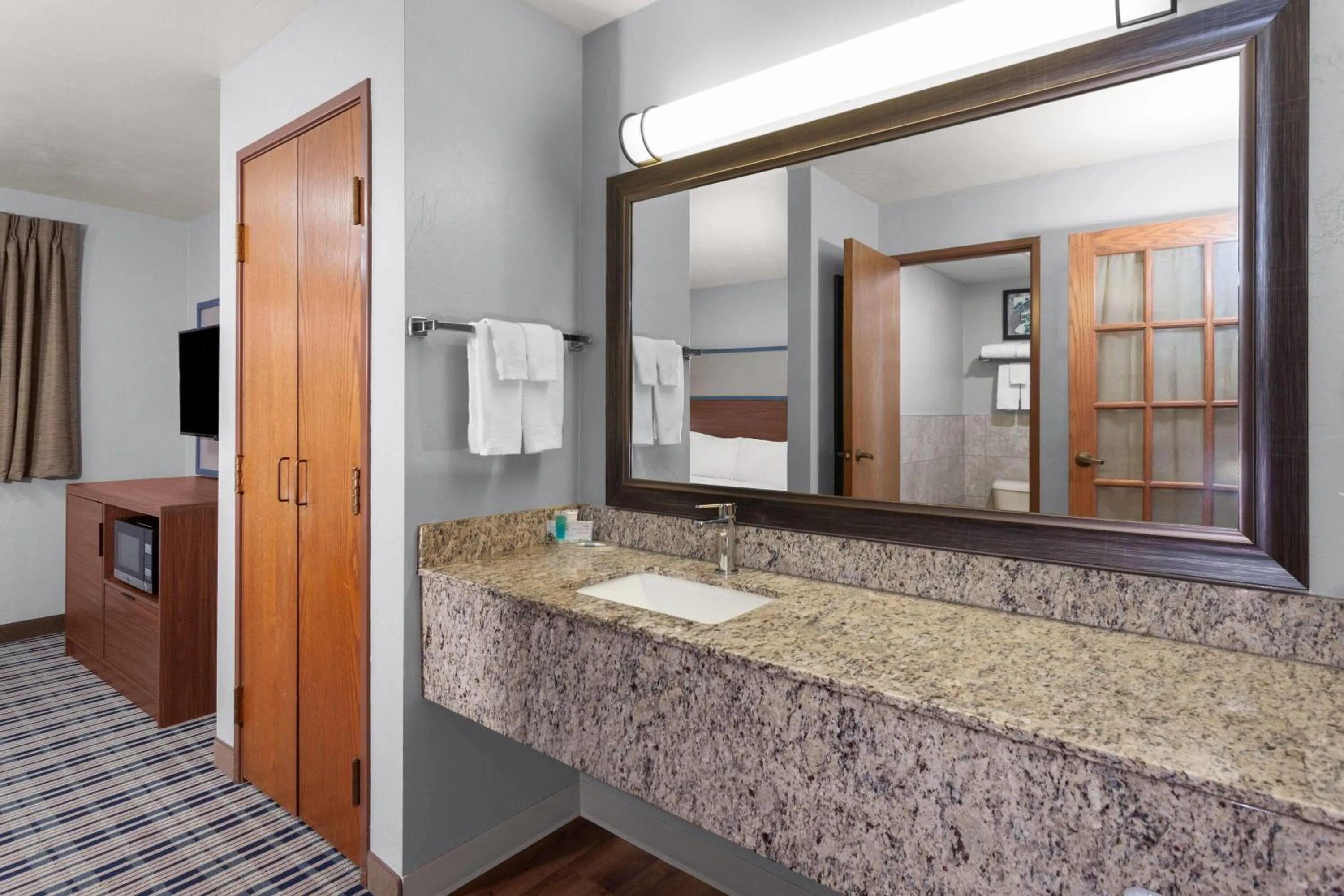 Bathroom, Bed in AmericInn by Wyndham Green Bay West