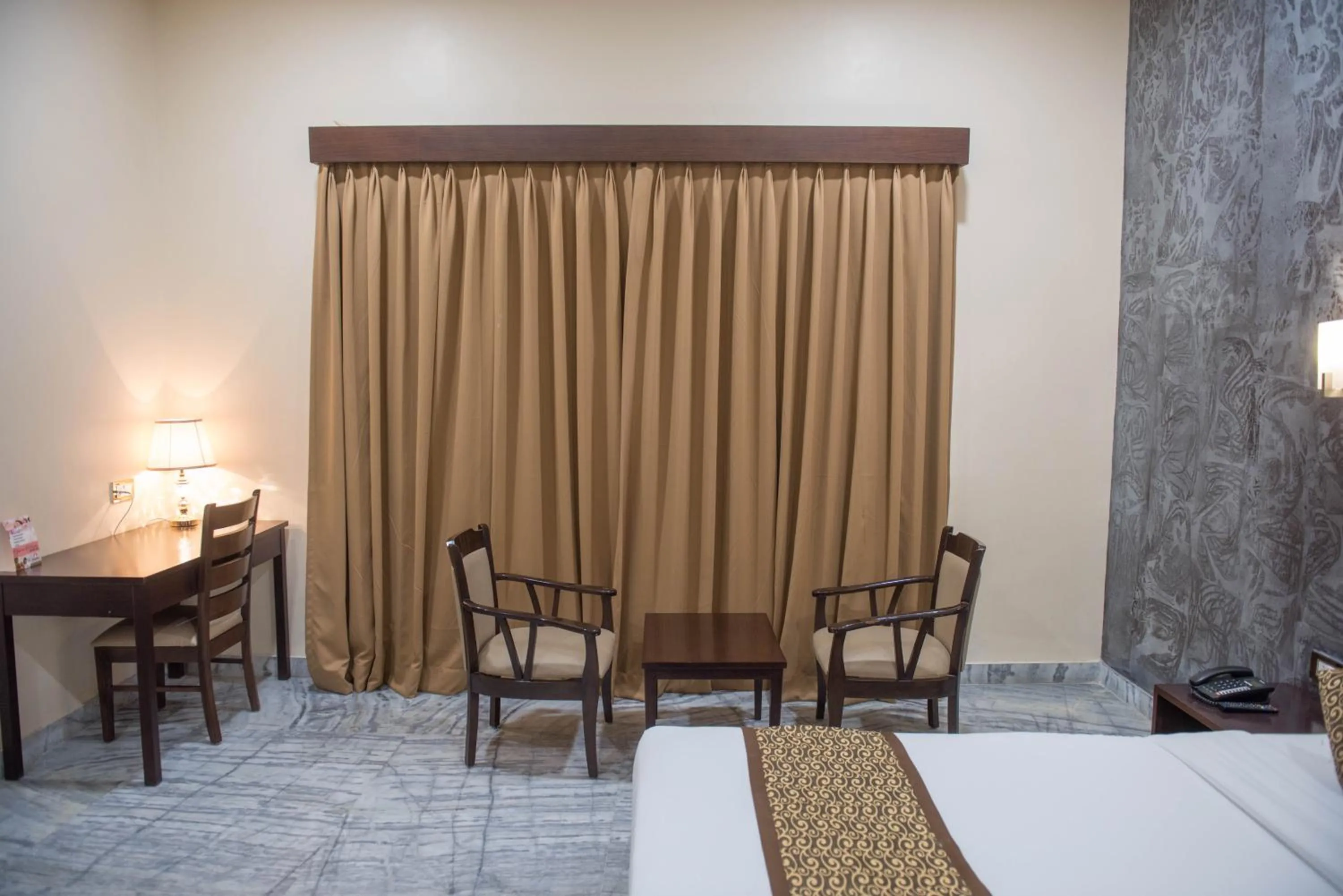 Seating area, Bed in Sun Hotel and Resort, Mount Abu