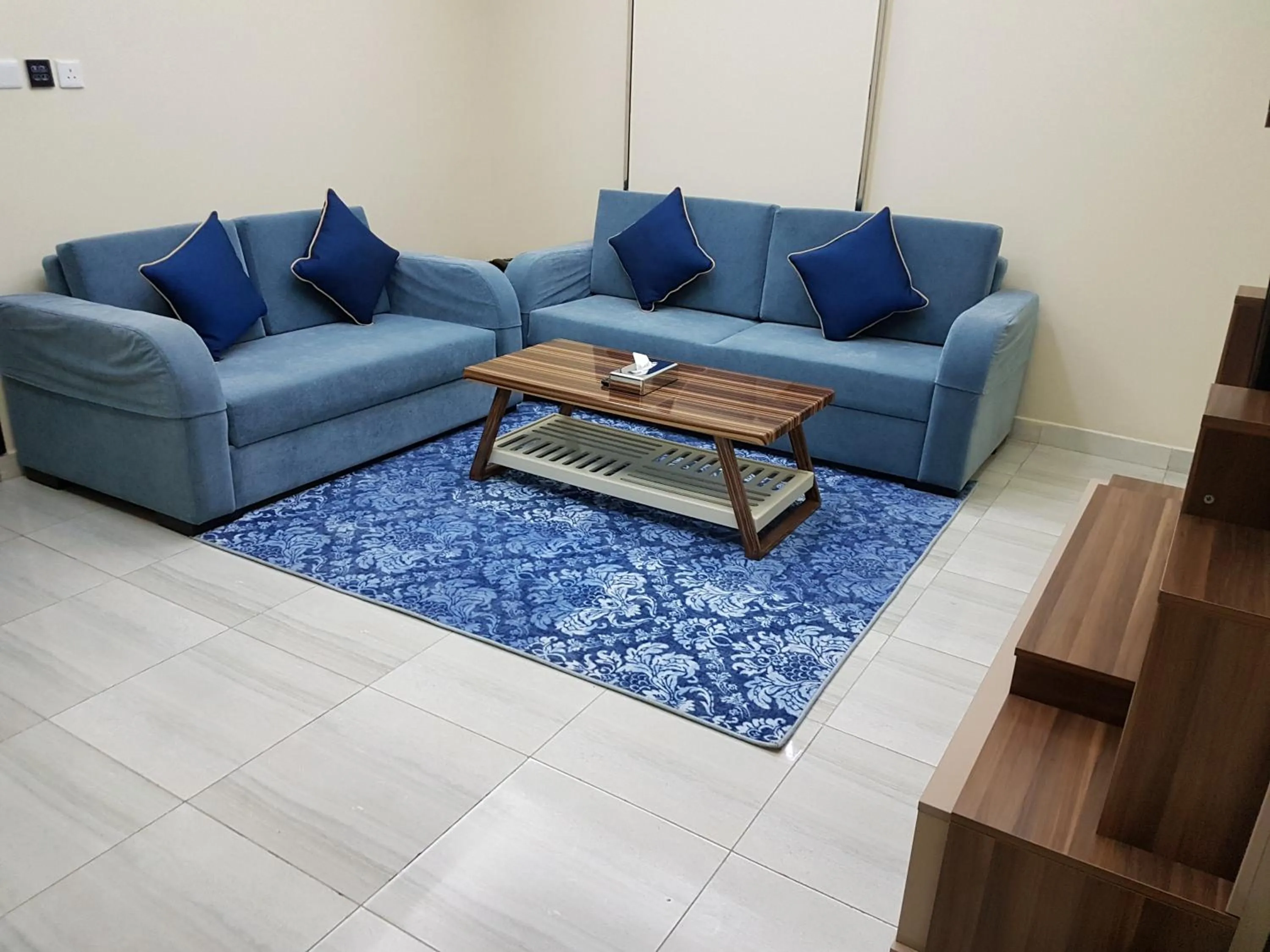 Living room in Swiss Blue serviced Apartments- Al Zahra