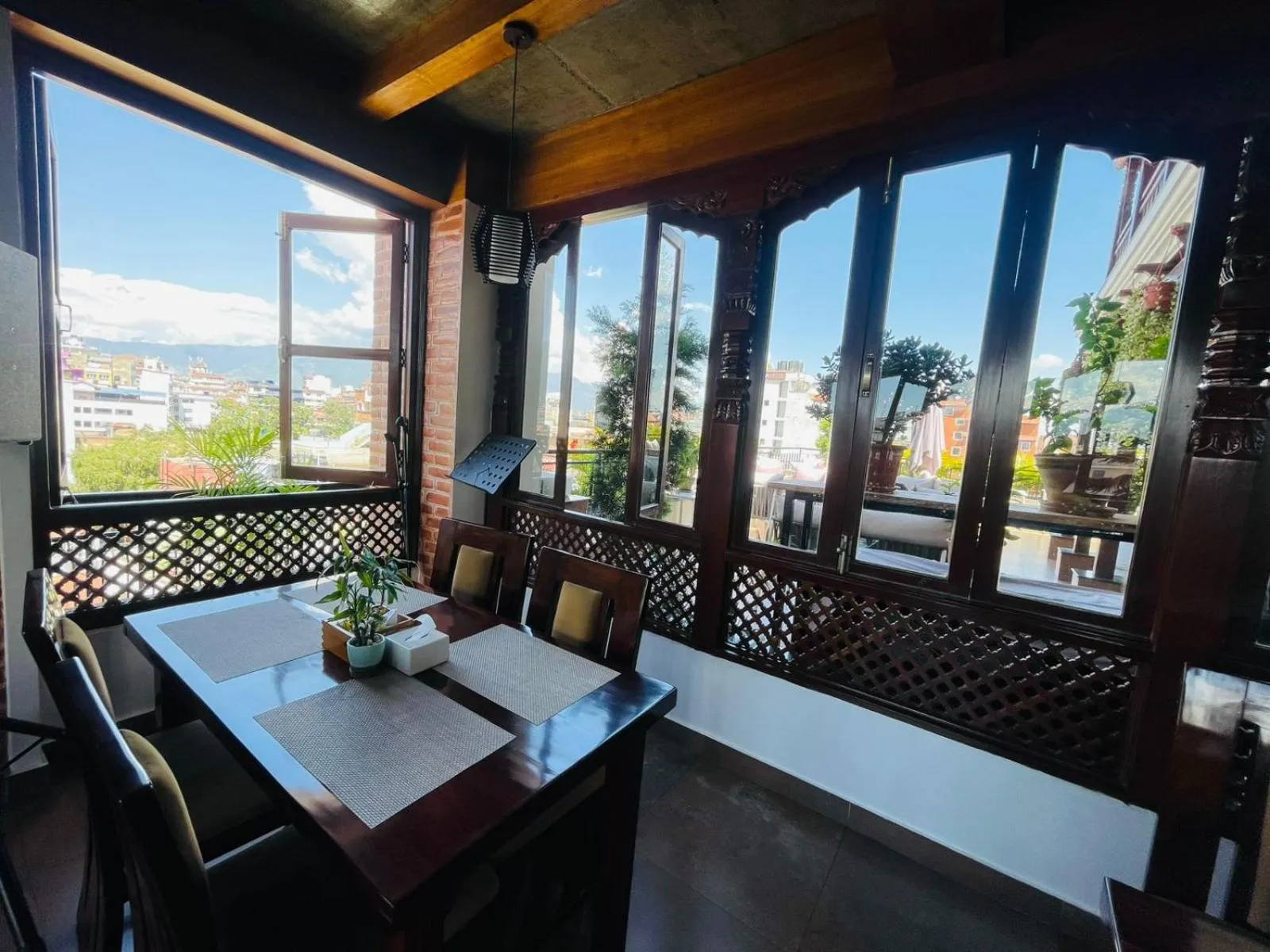 Dining area in Timber House by Tara Group