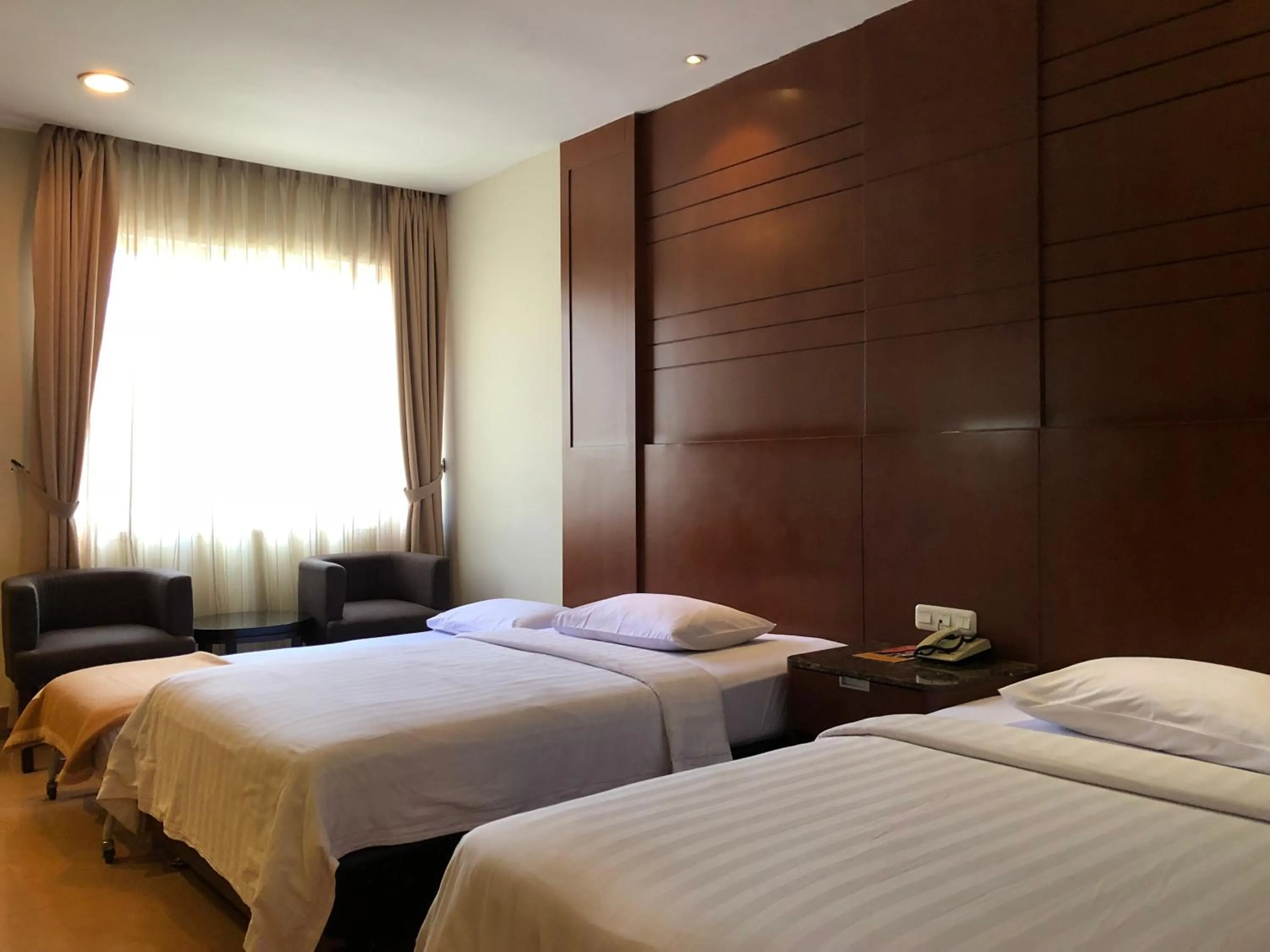 Bed in Grand Sakura Hotel